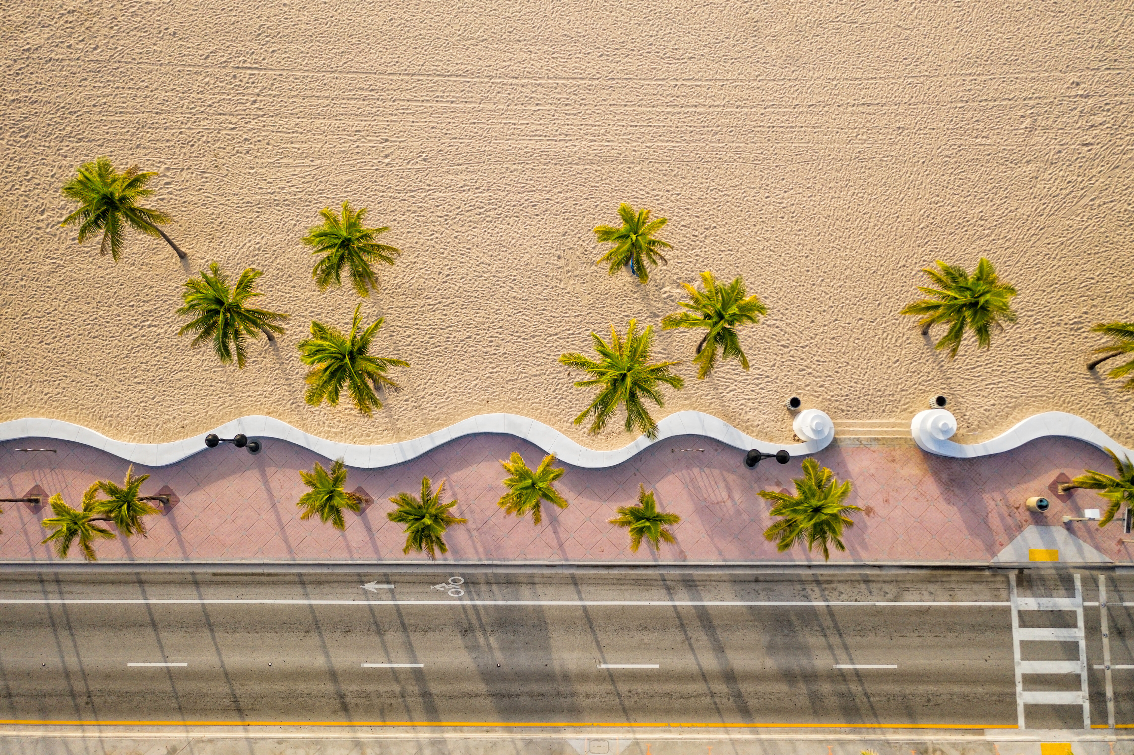 Aerial view of the palm-lined beach walkway in Fort Lauderdale, Florida—an iconic coastal promenade near luxury hotels, marinas, and top charter departure points | Fraser Yachts