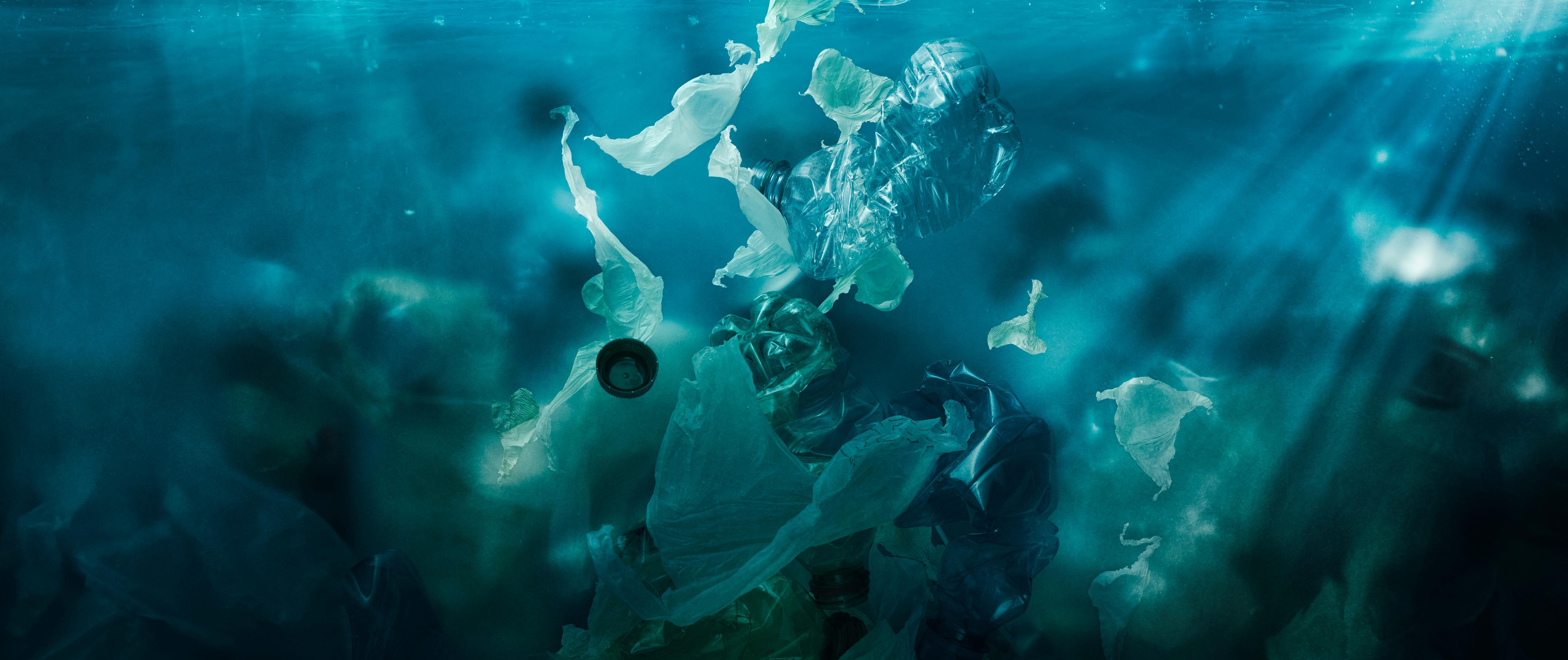 Toxic plastic waste floating underwater in the ocean, representing contamination and environmental hazards. | Dirty, Contamination, Hazard, Underwater, Pollution | Fraser