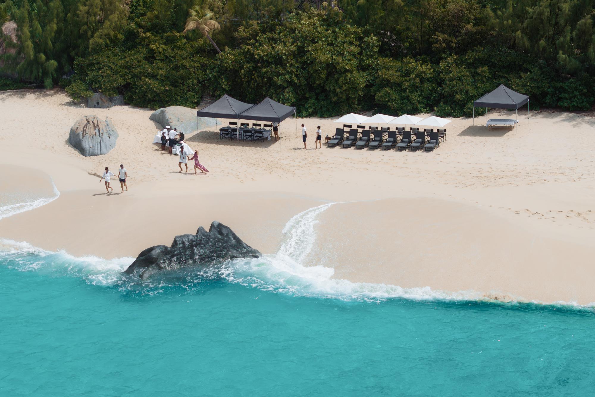 A stunning sky view of the beach setup for the CARINTHIA VII yacht, featuring elegant seating arrangements and luxurious decor that enhance the outdoor experience. | CARINTHIA VII yacht, beach setup, sky view, luxury outdoor experience | Fraser Yachts