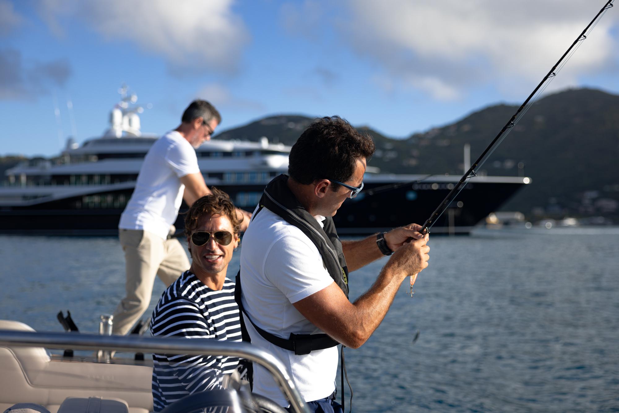 carinthiaVII-lifestyle-three-men-fishing-boat-in-background_fraseryachts-3kGtjJZc.jpg