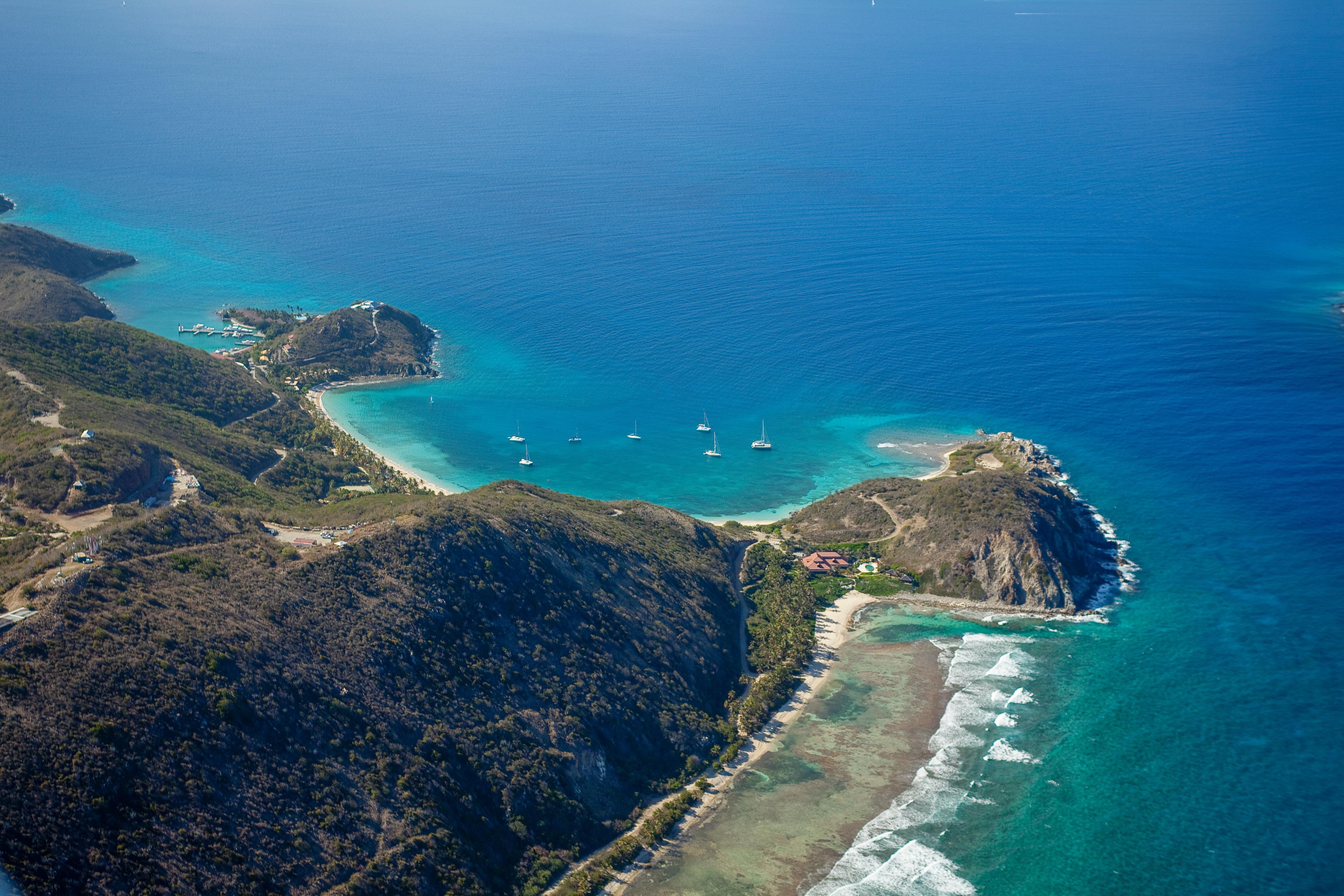 Aerial view of Peter Island and Dead Man Bay, British Virgin Islands—secluded beaches, turquoise waters, and a scenic Caribbean anchorage ideal for yacht charters | Fraser Yachts