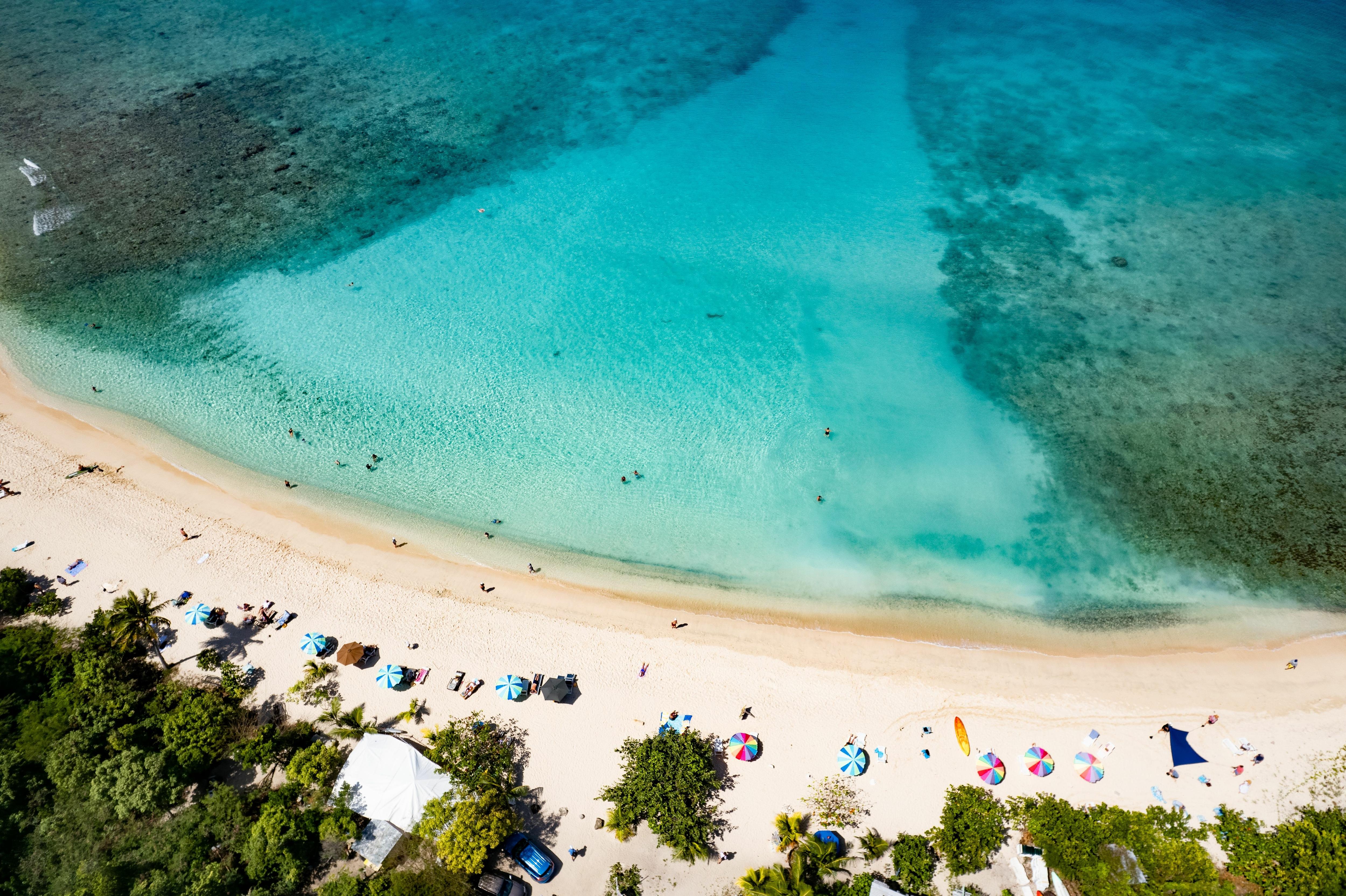 Smuggler’s Bay Beach, Tortola, BVI—stunning shoreline framed by rocky headlands and lush greenery, ideal for quiet beach moments and private Caribbean yacht anchorages | Fraser Yachts