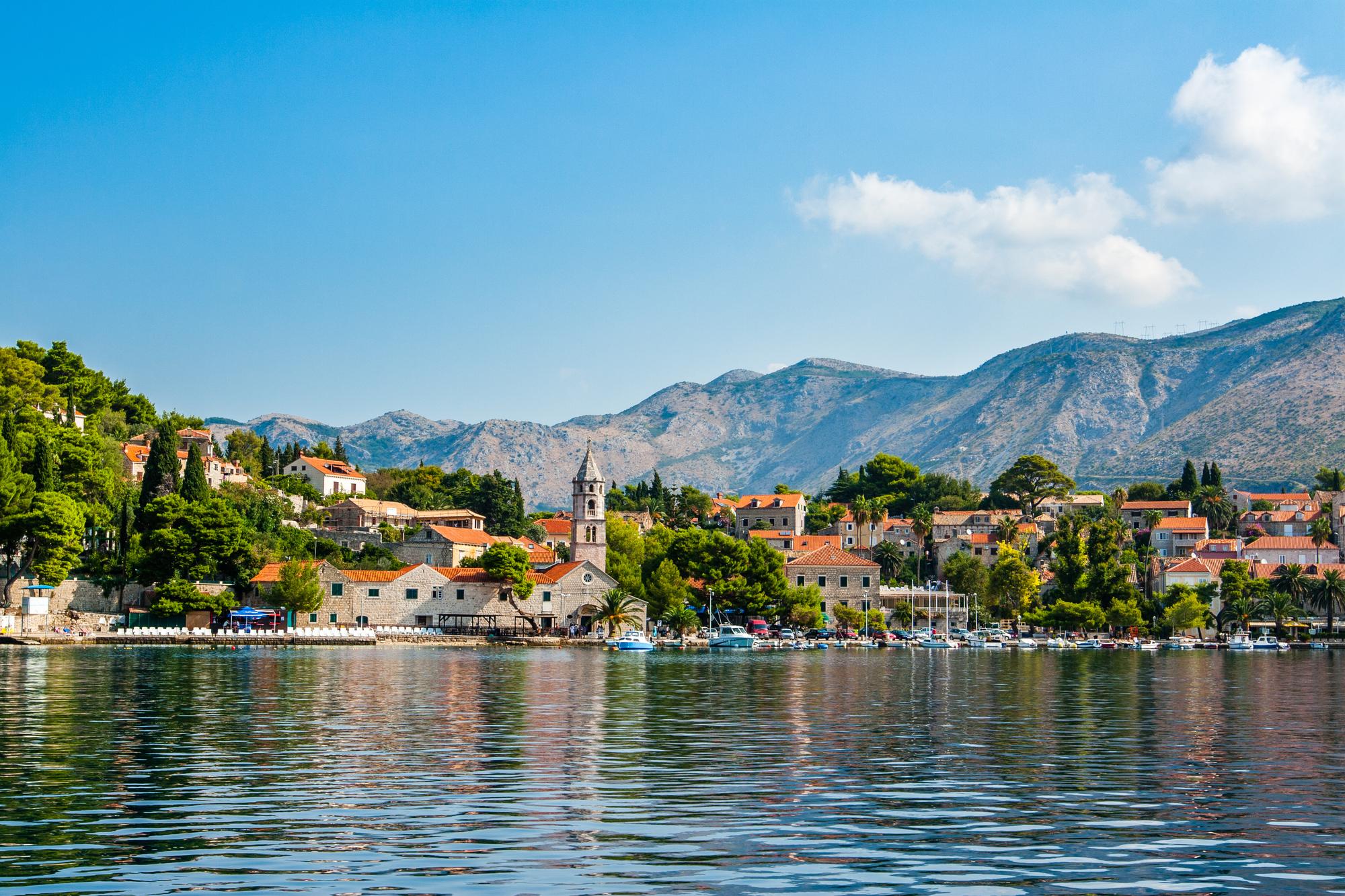 Discover the Mediterranean charm of Cavtat, Croatia, with its scenic boats, charming houses, and lush nature | Boat, house, nature, Mediterranean, Cavtat, Croatia | Fraser