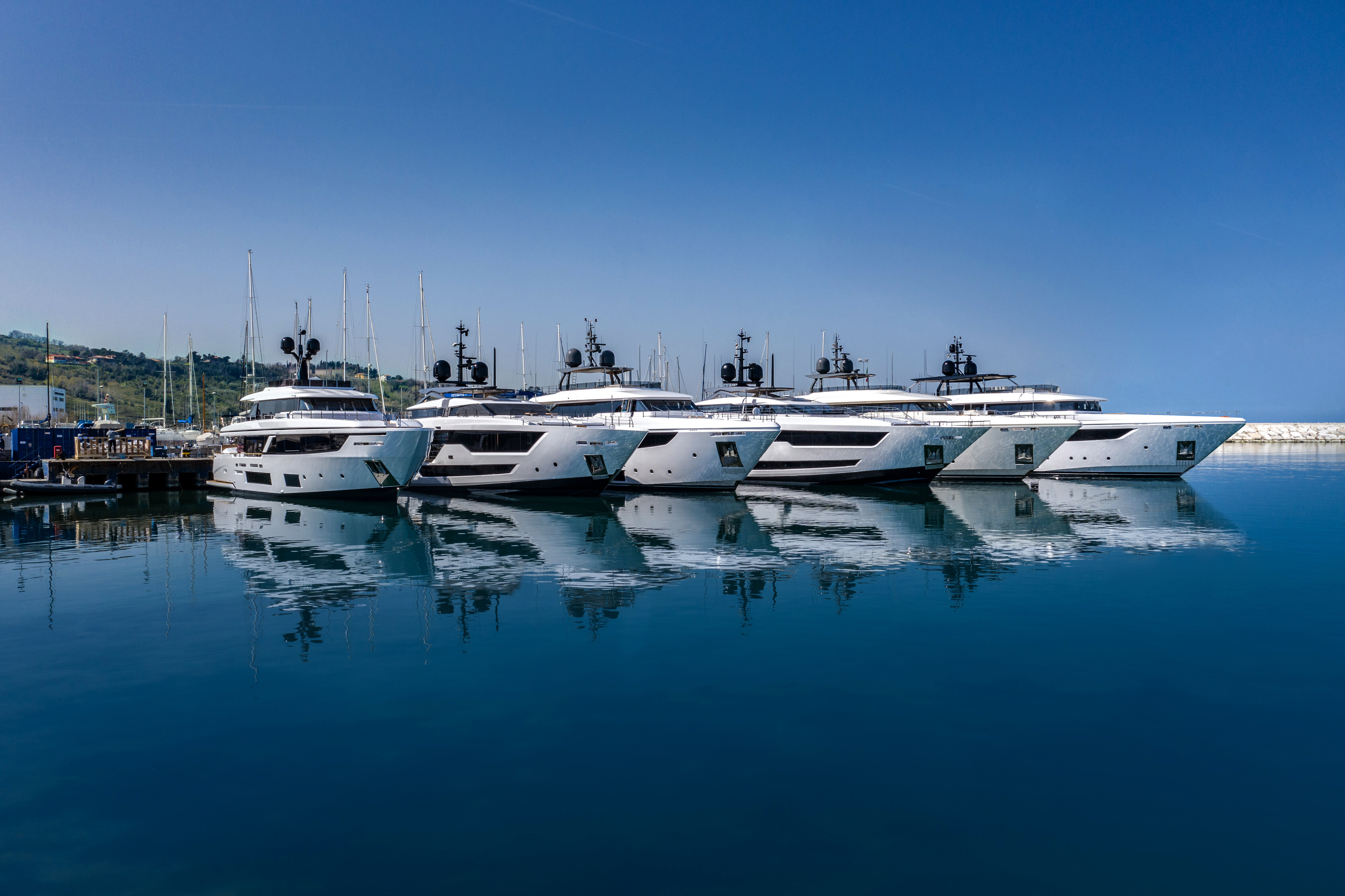 A stunning view of the Custom Line Shipyard dock, featuring sleek yachts and a vibrant marina atmosphere, ideal for luxury yacht enthusiasts. | Custom Line Shipyard, dock, marina, luxury yachts, yacht enthusiasts | Fraser Yachts