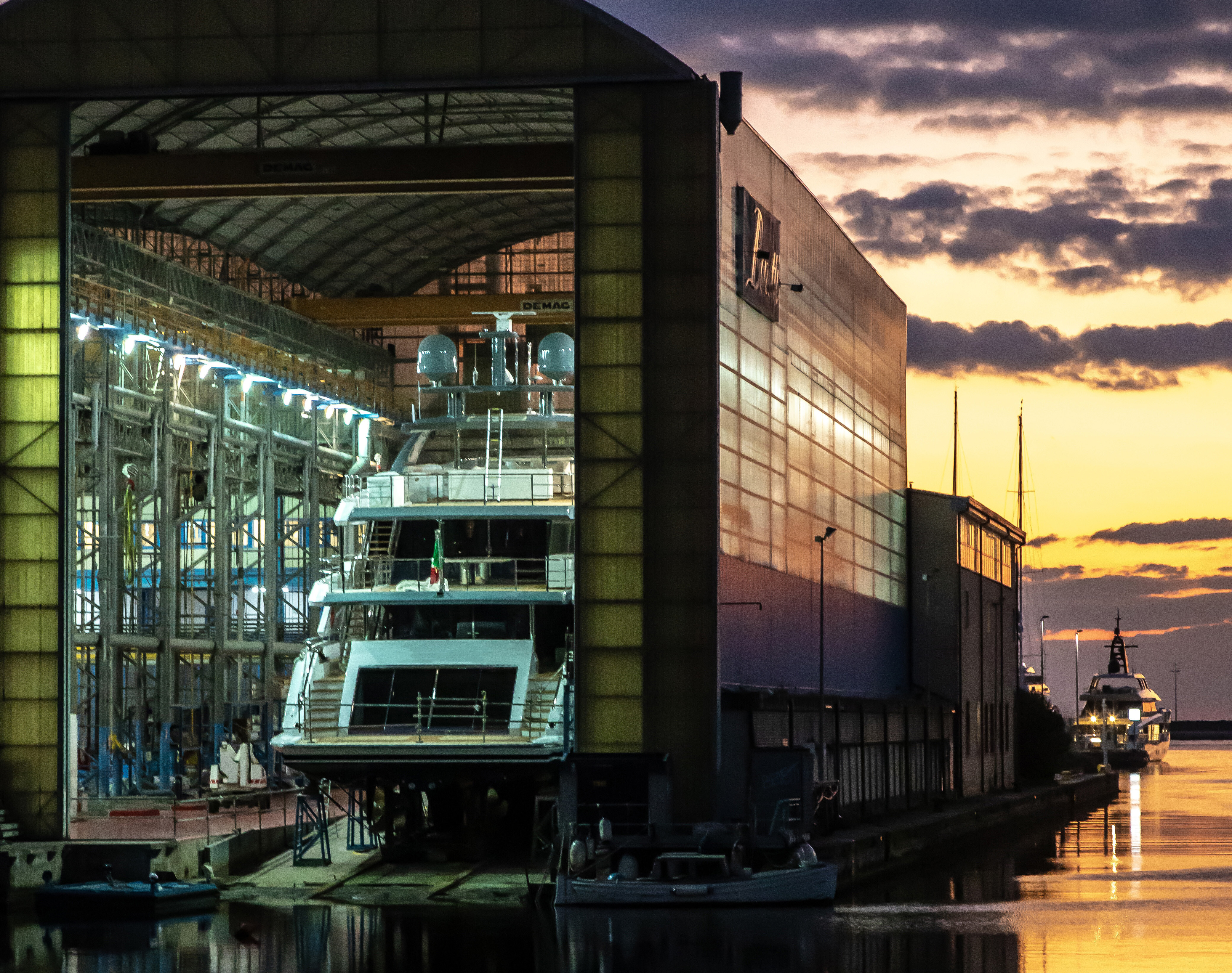 A stunning view of the Benetti Shipyard in Viareggio, showcasing the impressive facilities and luxurious yachts under construction, reflecting the brand's commitment to craftsmanship and innovation. | Benetti Shipyard, Viareggio, yacht construction, luxury yachts, craftsmanship, shipyard facilities | Fraser Yachts