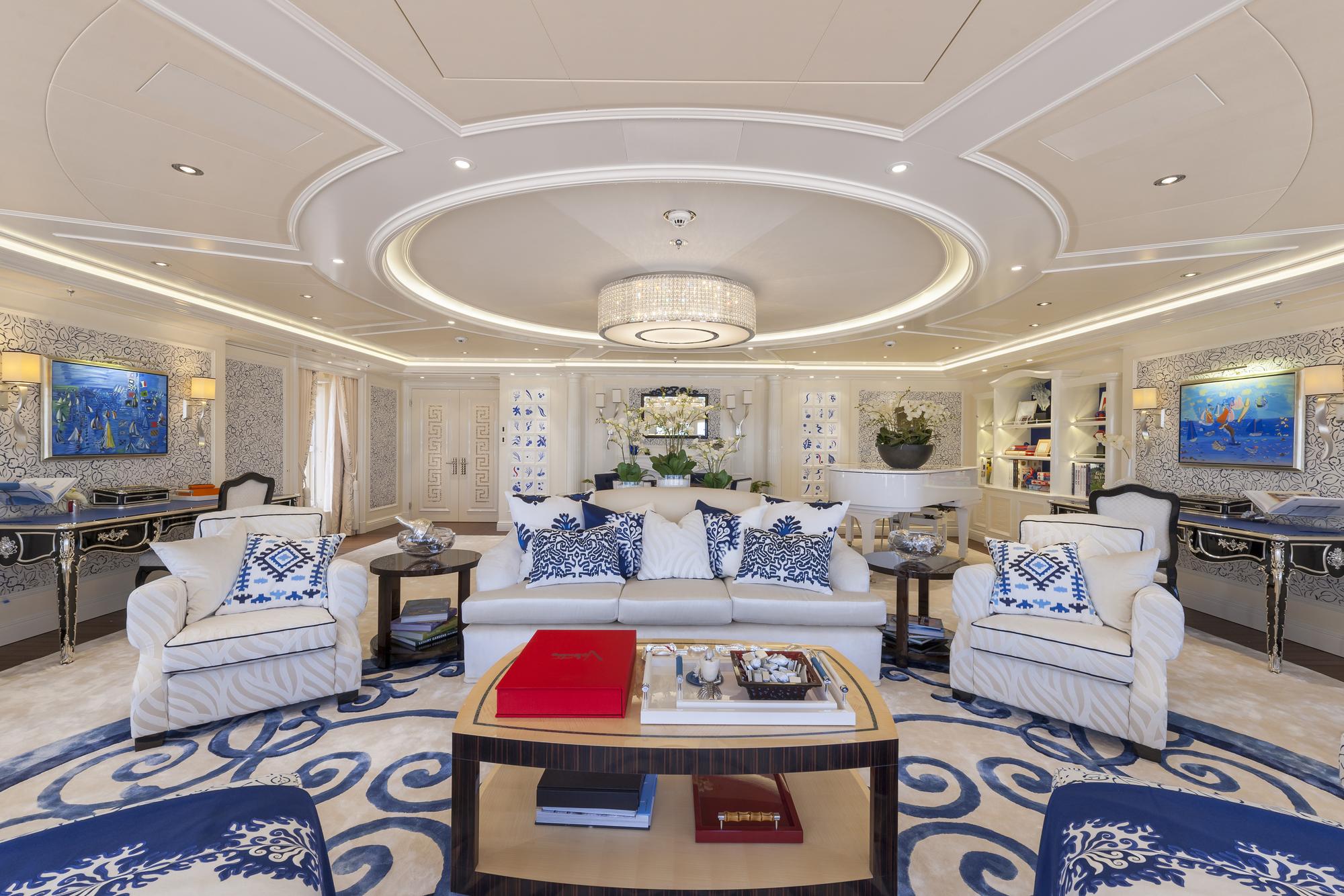 The spacious living room of a yacht designed by Andrew Winch, featuring sophisticated design and luxurious furnishings. | yacht living room, luxury yacht design, Andrew Winch yacht interiors | Fraser Yachts