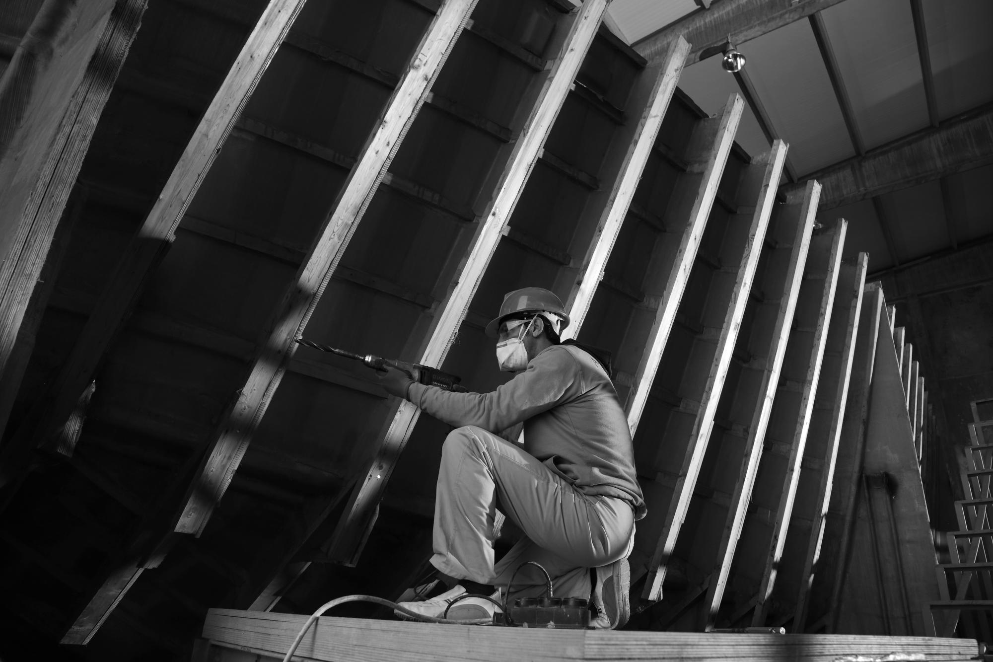 A skilled builder working on the rails of a yacht during the construction process at Ameller Build. | yacht construction, boat building, Ameller Build, yacht rails | Fraser Yachts