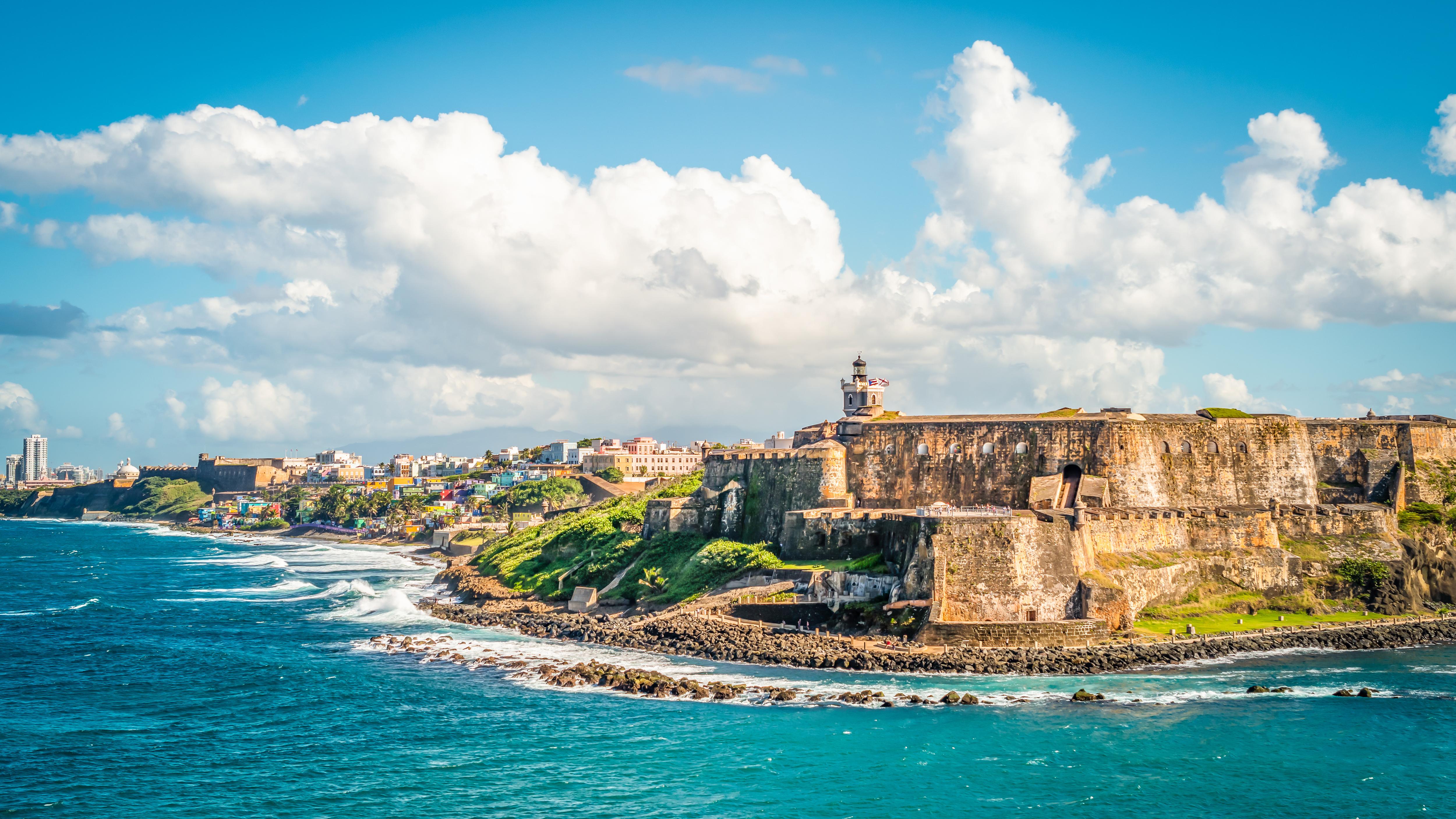 Explore the rich history and vibrant tourism of Old San Juan, Puerto Rico, with its stunning views of the ocean and iconic castle amidst the picturesque skyline | Tourism, sky, ocean, cruise, castle, Old San Juan, Puerto Rico | FRASER