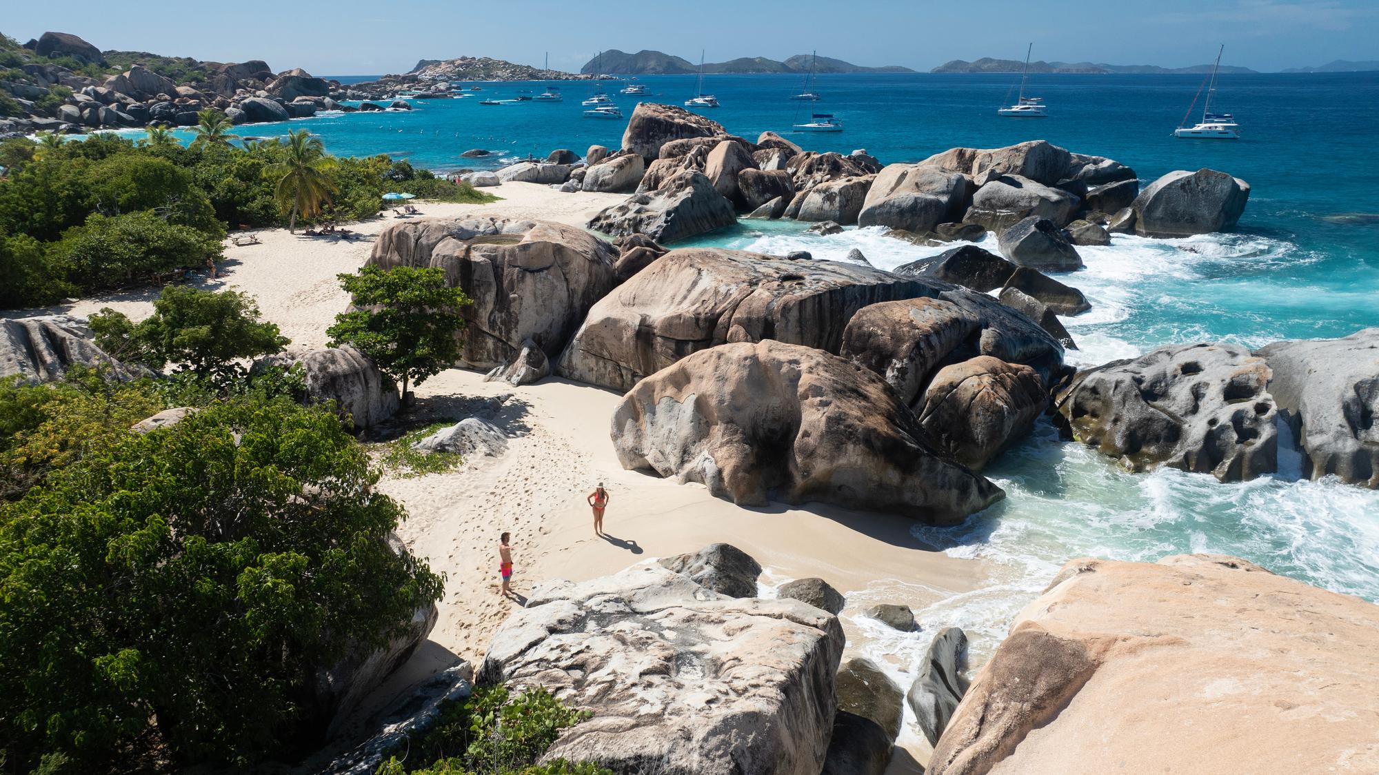 Discover the rugged beauty of the British Virgin Islands with its dramatic cliff formations, rocky shores, sandy beaches, and crashing waves | Cliff, rocks, sand, sea, view, waves, British Virgin Islands | FRASER