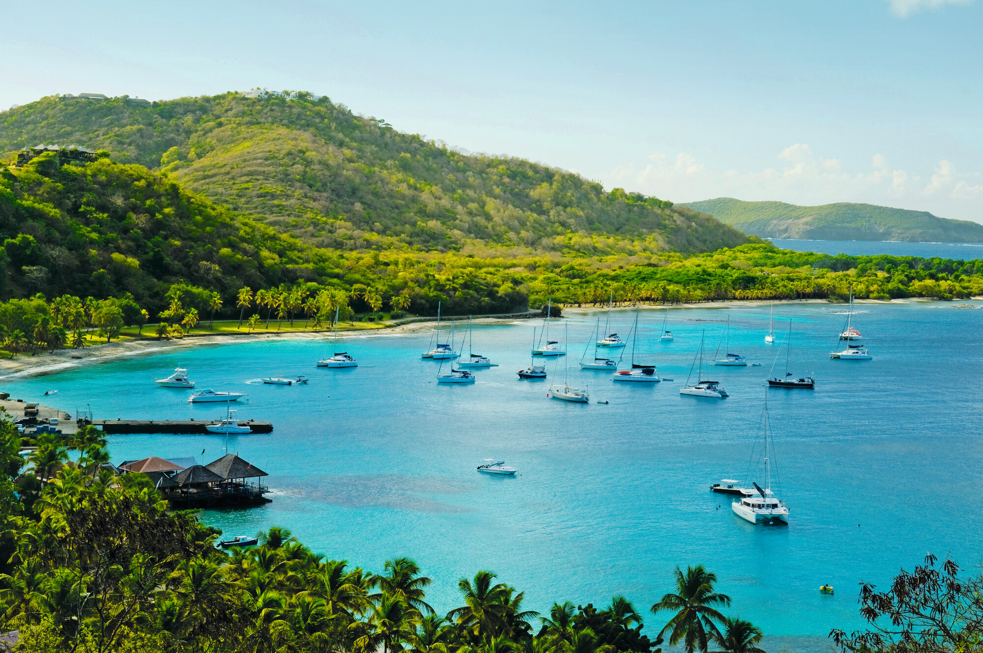 Experience the picturesque sailboat landscape from Britannia Bay in St. Vincent, part of the Windward Islands in the Caribbean, with Fraser Yachts. | Caribbean, Windward Islands, St. Vincent, Britannia Bay, yachts, sail, landscape, yacht charter | Fraser