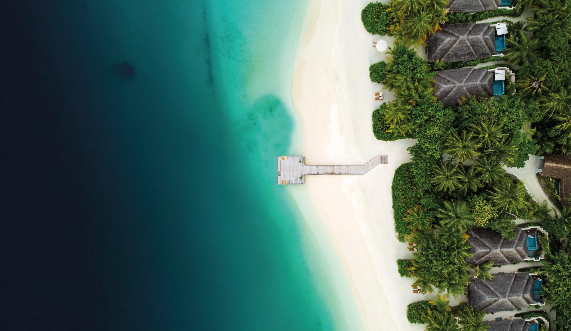 Savor an aerial view of the Maldives' beaches, ocean, and luxurious bungalows with pools | Maldives, aerial view, beach, ocean, bungalows, pools | Fraser