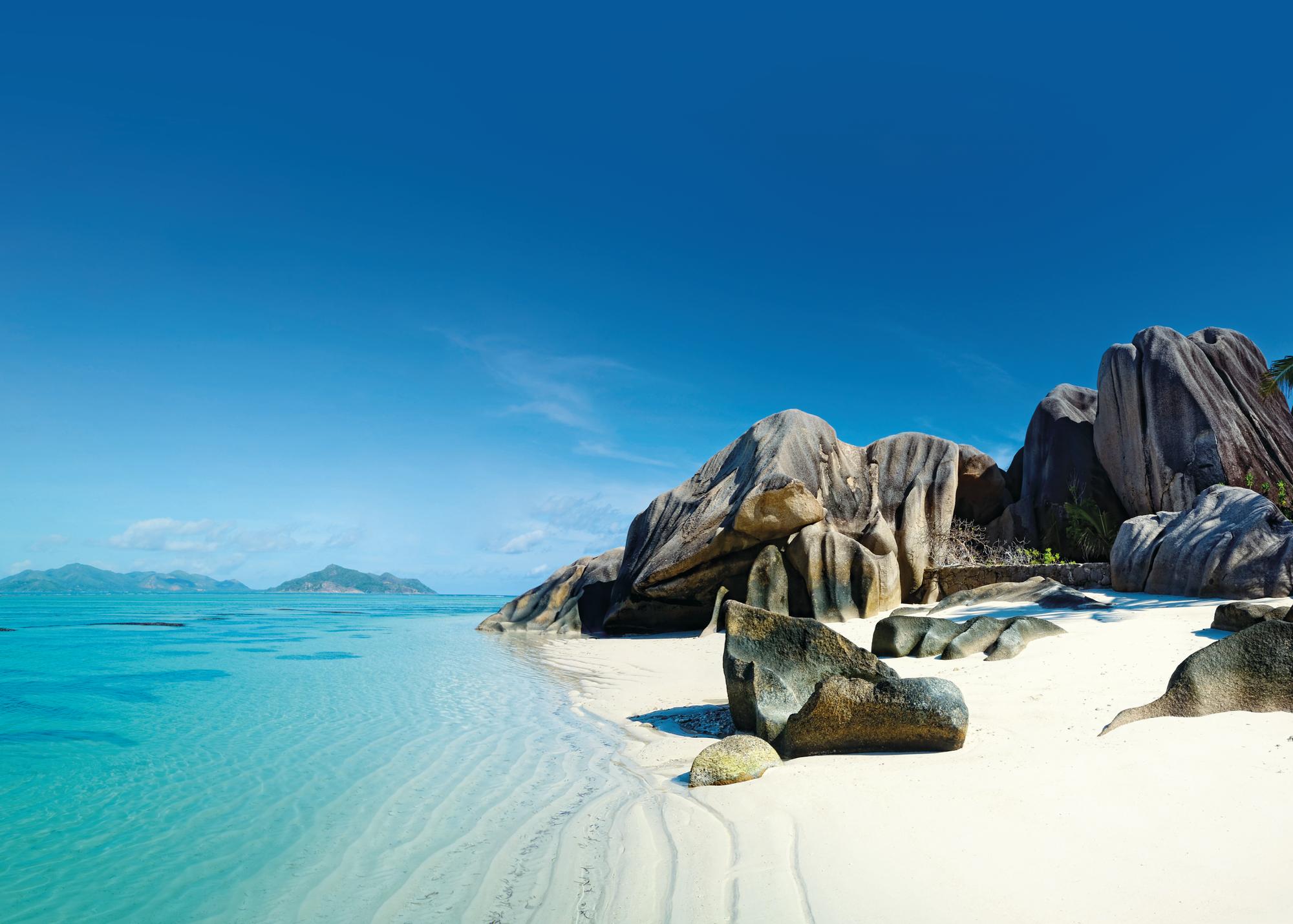 Explore the picturesque coastline of Seychelles with its pristine beaches, rocky outcrops, and white sand | Indian Ocean, Seychelles, beach, coastline, rocks, white sand | Fraser