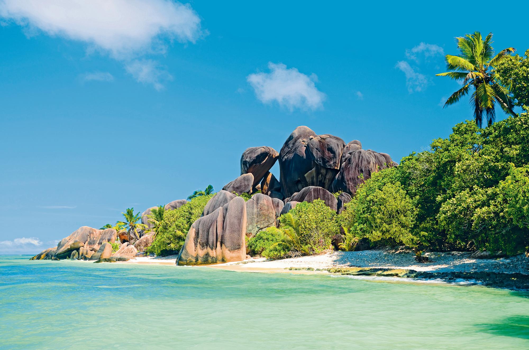 Discover the stunning landscape of Seychelles, featuring the iconic granite rocks of La Digue island | Indian Ocean, Seychelles, granite rocks, La Digue island | Fraser