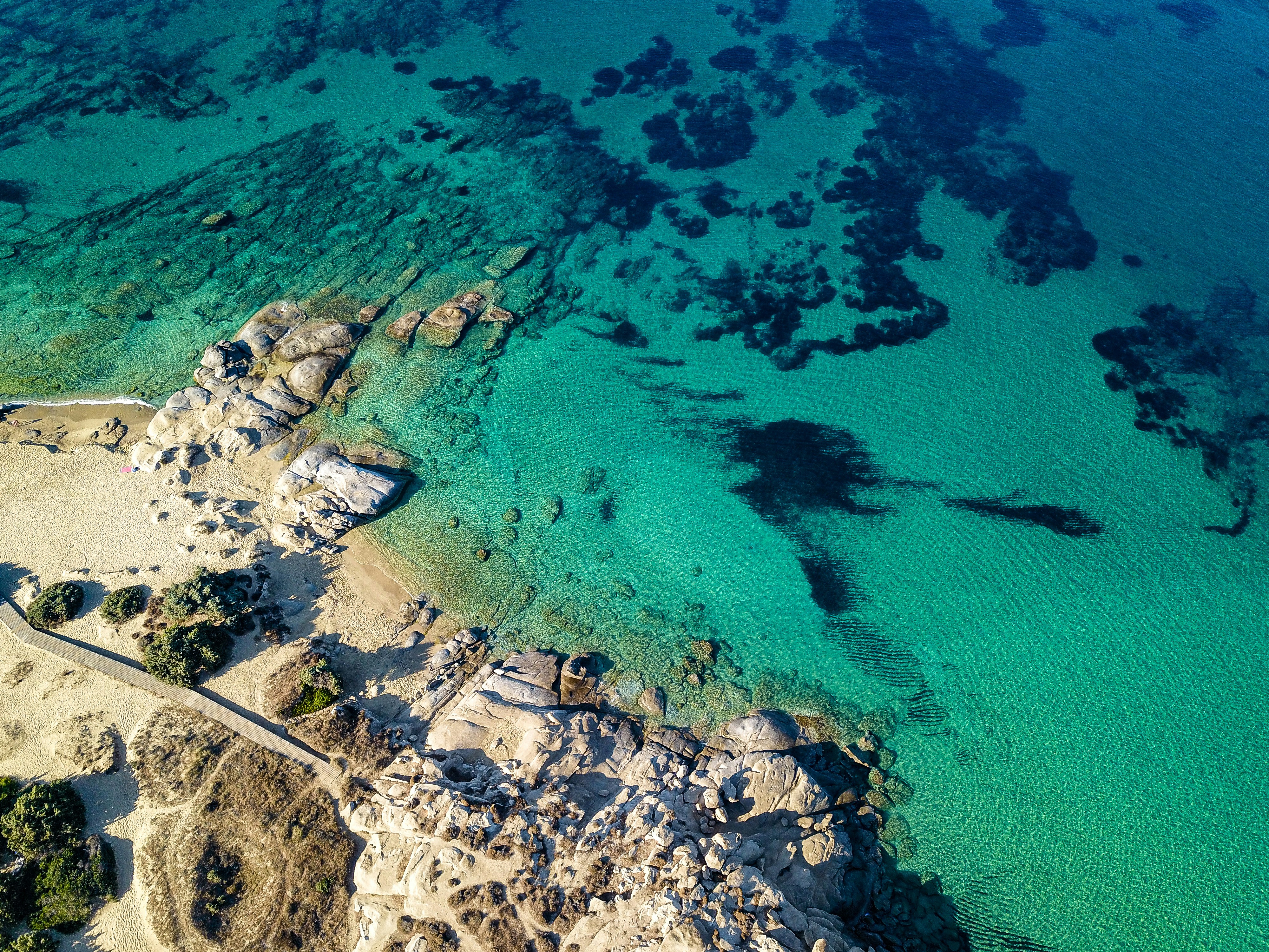 Aerial view of Naxos, Greece—crystal-clear turquoise waters and rocky coves create a pristine Mediterranean coastline, ideal for yacht anchoring, swimming, and island exploration | Fraser Yachts