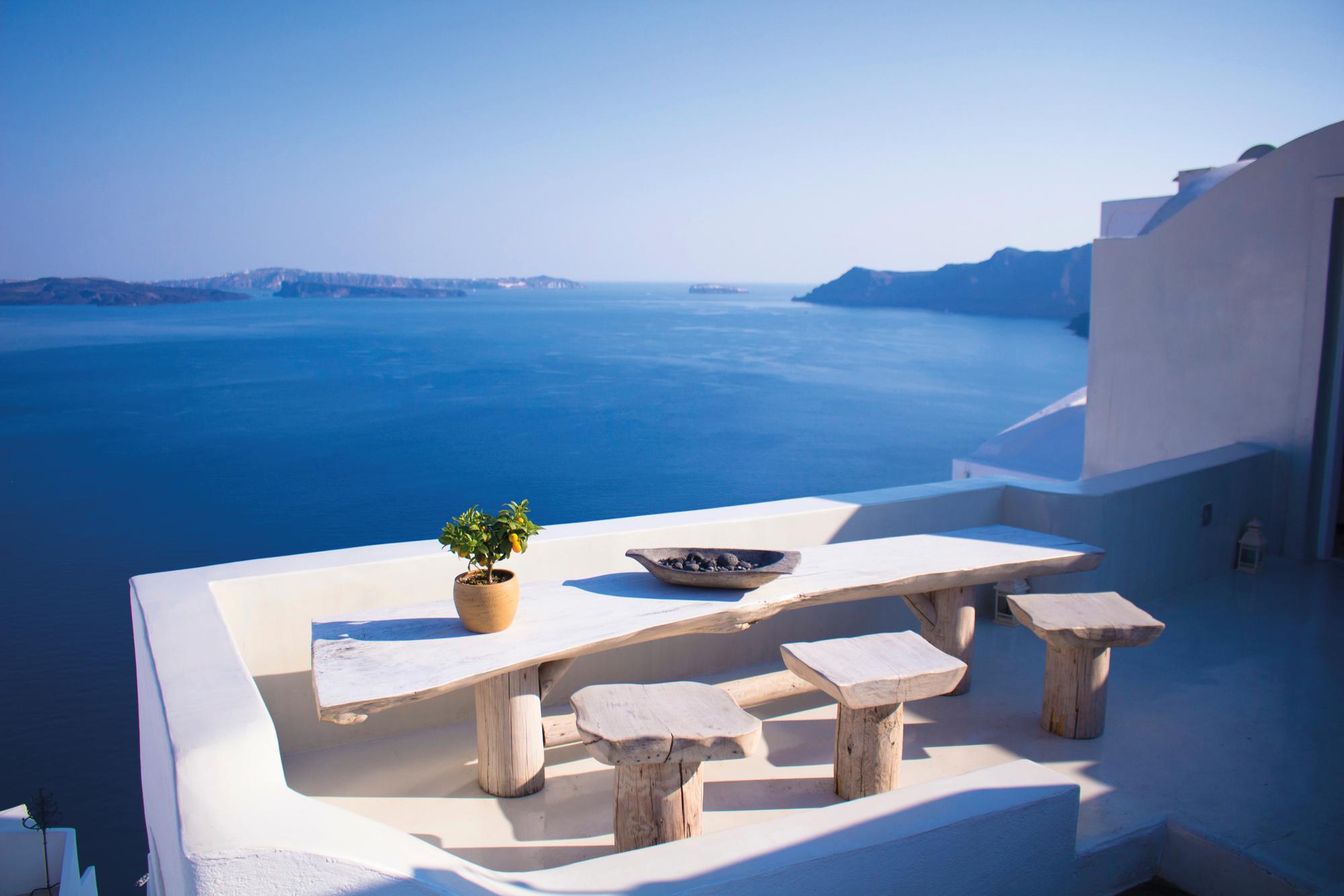 Savor the Mediterranean breeze from a terrace overlooking the sea in Santorini, Greece, with Fraser Yachts. | Mediterranean, Greece, Santorini, terrace, sea view, yacht charter | Fraser