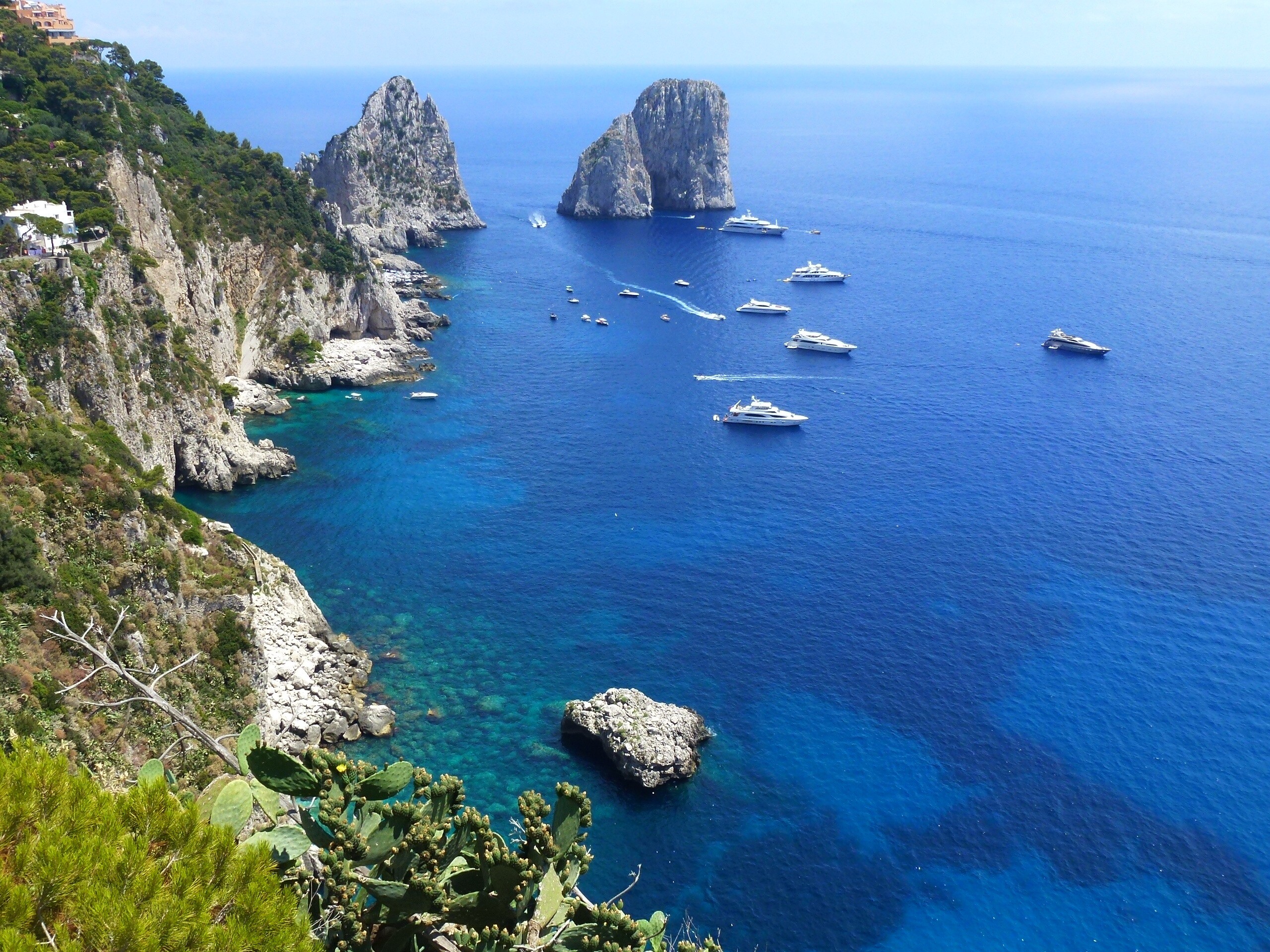 Faraglioni rocks off Capri, Italy—dramatic limestone formations rising from deep blue waters, one of the Mediterranean’s most iconic yacht destinations | Fraser Yachts