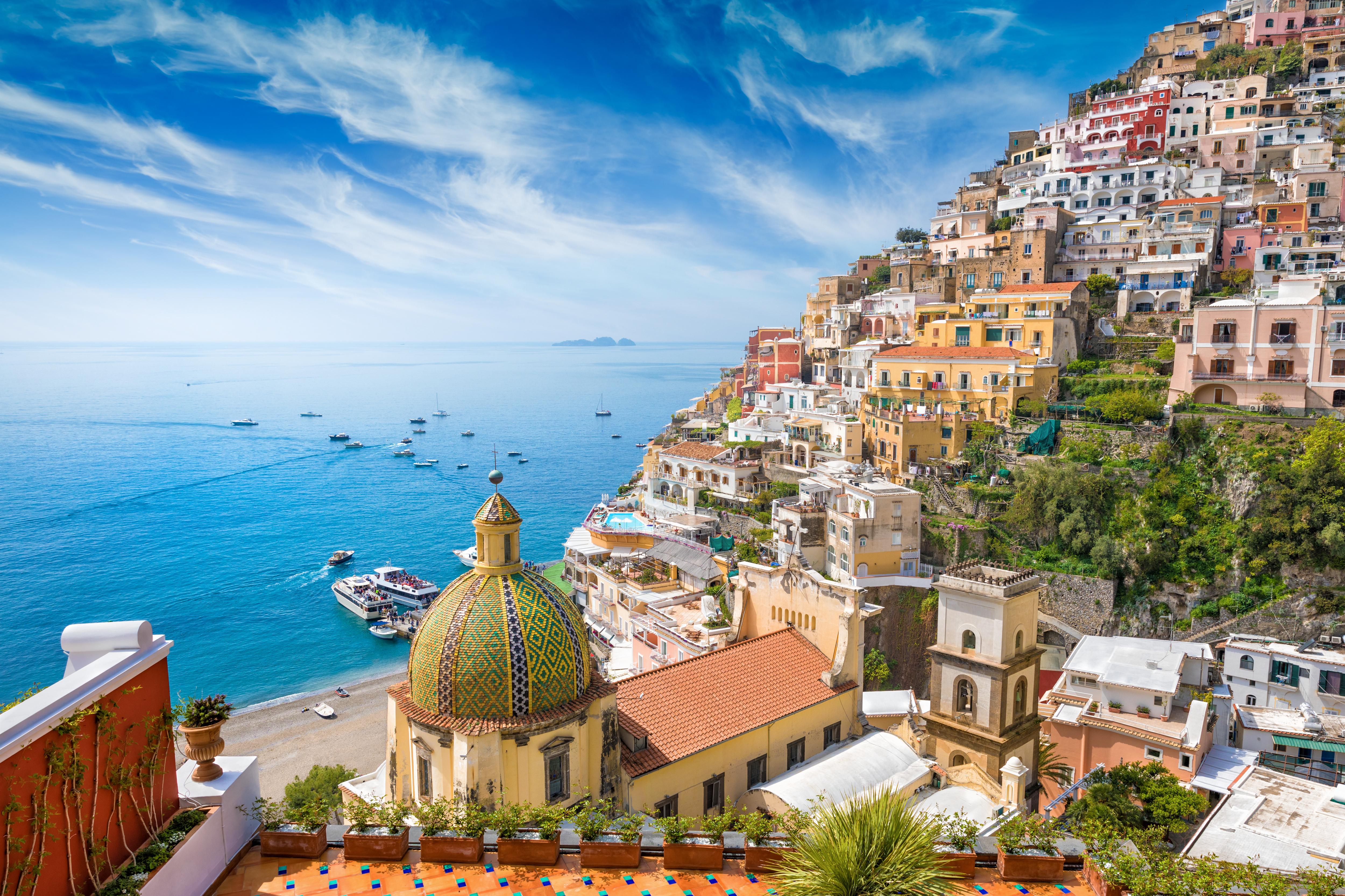 Positano on the Amalfi Coast, Italy—iconic Santa Maria Assunta dome and colorful cliffside houses overlooking the sea, a must-visit destination for Mediterranean yacht charters | Fraser Yachts