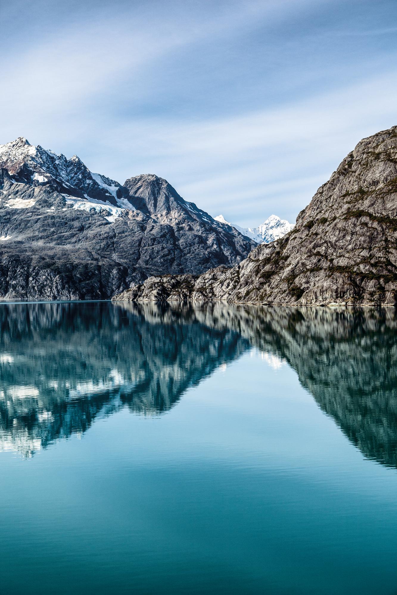 Embrace the stunning vistas of Alaska's rugged coast and snowy mountains | North America, Alaska, coast, mountain, snow | FRASER