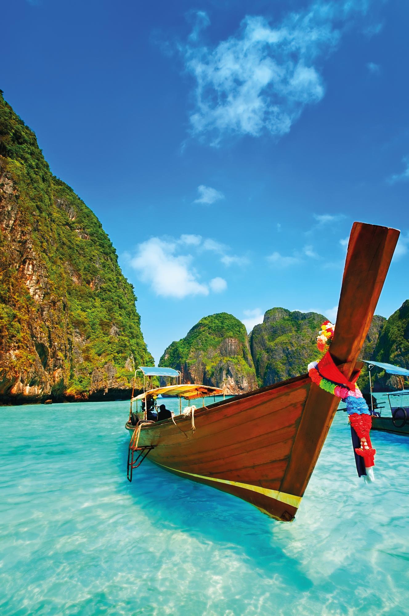 Experience the iconic longtail boats and the stunning Phi Phi Islands in Thailand, Southeast Asia, with Fraser Yachts. | Southeast Asia, Thailand, longtail boats, Phi Phi Islands, yacht charter | Fraser