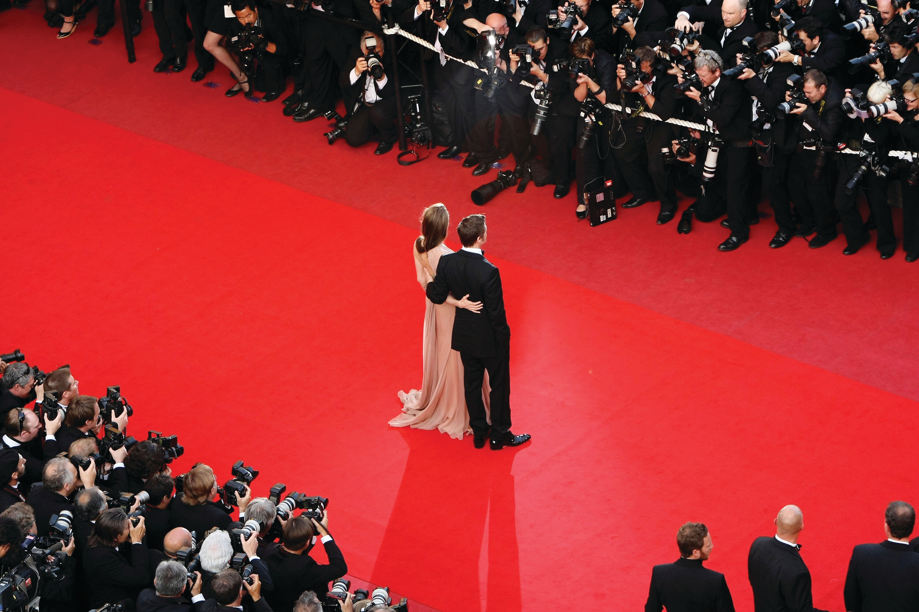 Step into the world of glitz and glamour with this stunning red carpet moment. A beautifully dressed couple is greeted by flashing cameras at a high-profile celebrity event, showcasing elegance, style, and prestige.