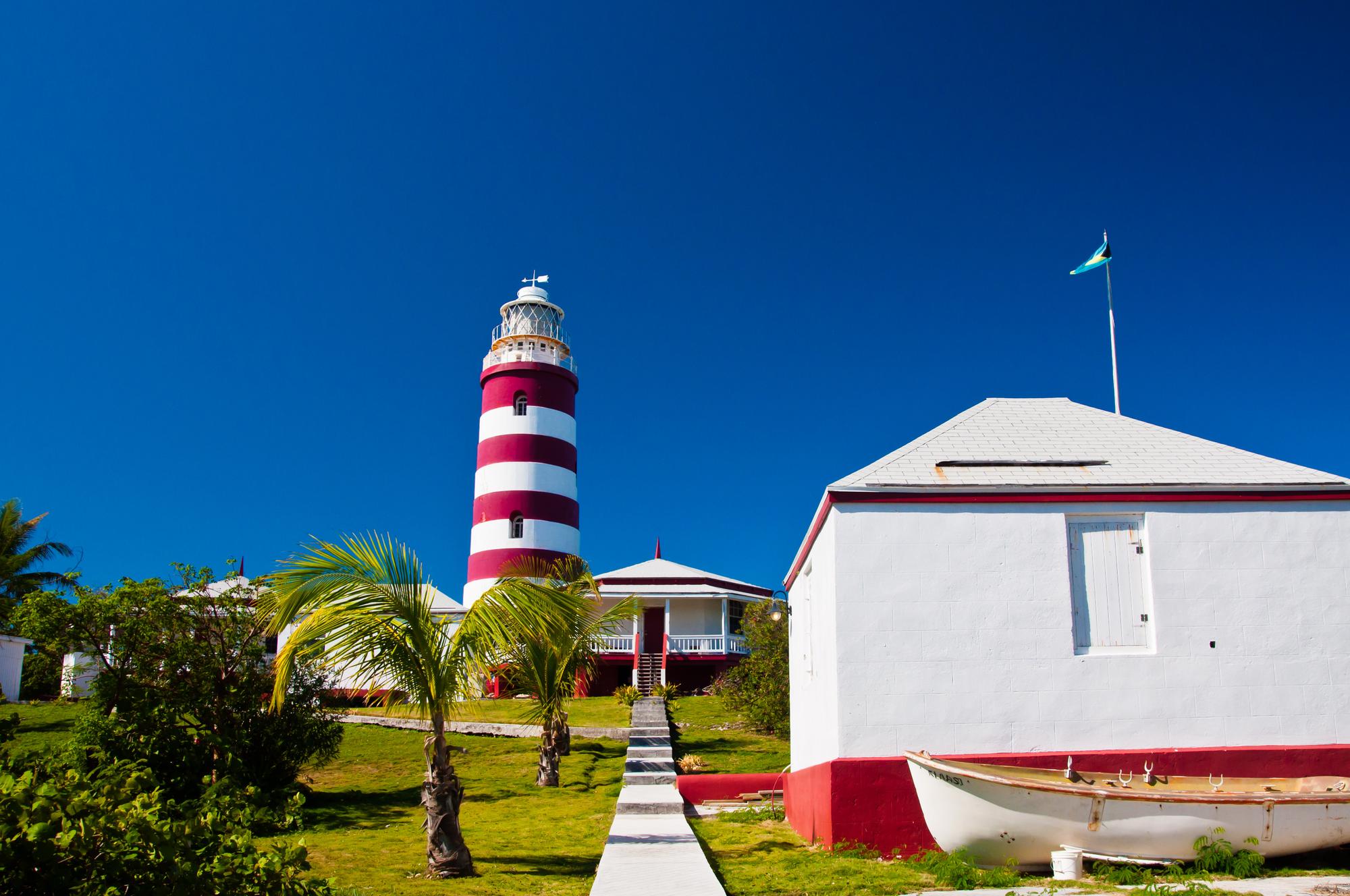 Marvel at the scenic beauty of Hope Town lighthouse on the Abacos coast in the Bahamas, overlooking the vast ocean | Coast, ocean, scenic, Hope Town lighthouse | FRASER