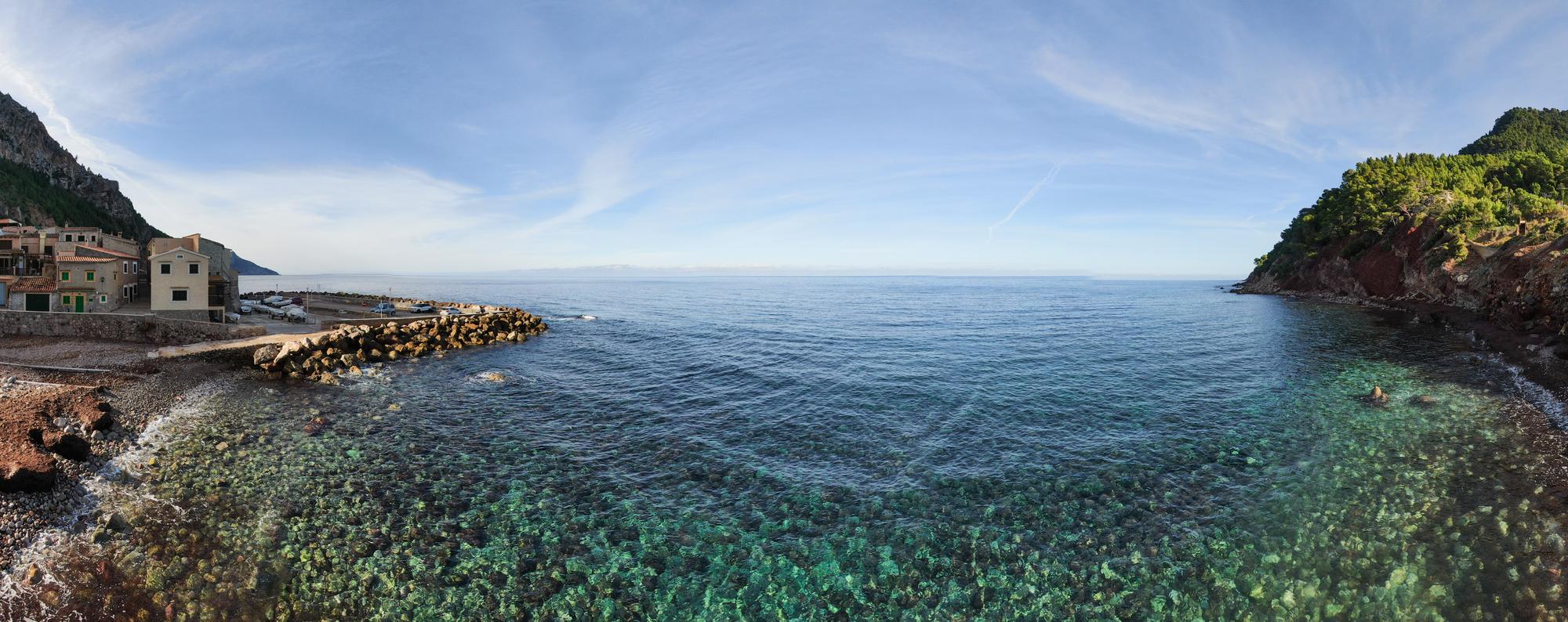 Experience the picturesque Cala Banyalbufar Beach on the stunning coastline of the Balearic Islands, Spain, offering a panoramic view of its beauty | Beach, island, coastline, panoramic view | Fraser