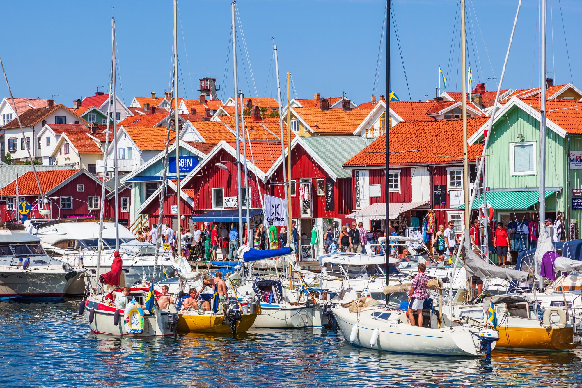 Experience the beauty of Smögen’s harbor with vibrant boats and a quaint village setting on the stunning Baltic coast | Boats, Village, Harbor, Picturesque | Fraser