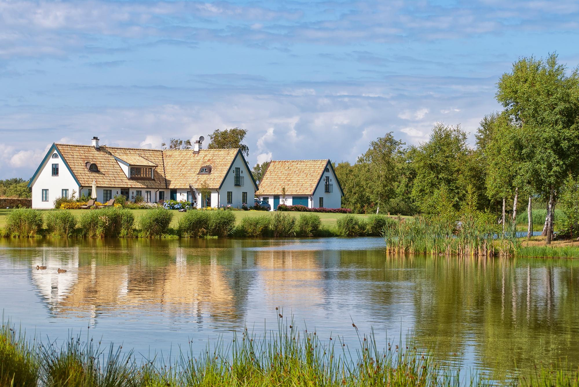 Discover a peaceful Scandinavian retreat with a rustic wooden cottage set in the serene rural landscapes of Sweden | Cottage, Outdoor, Rural, Scandinavian, Tranquil, Wooden | Fraser