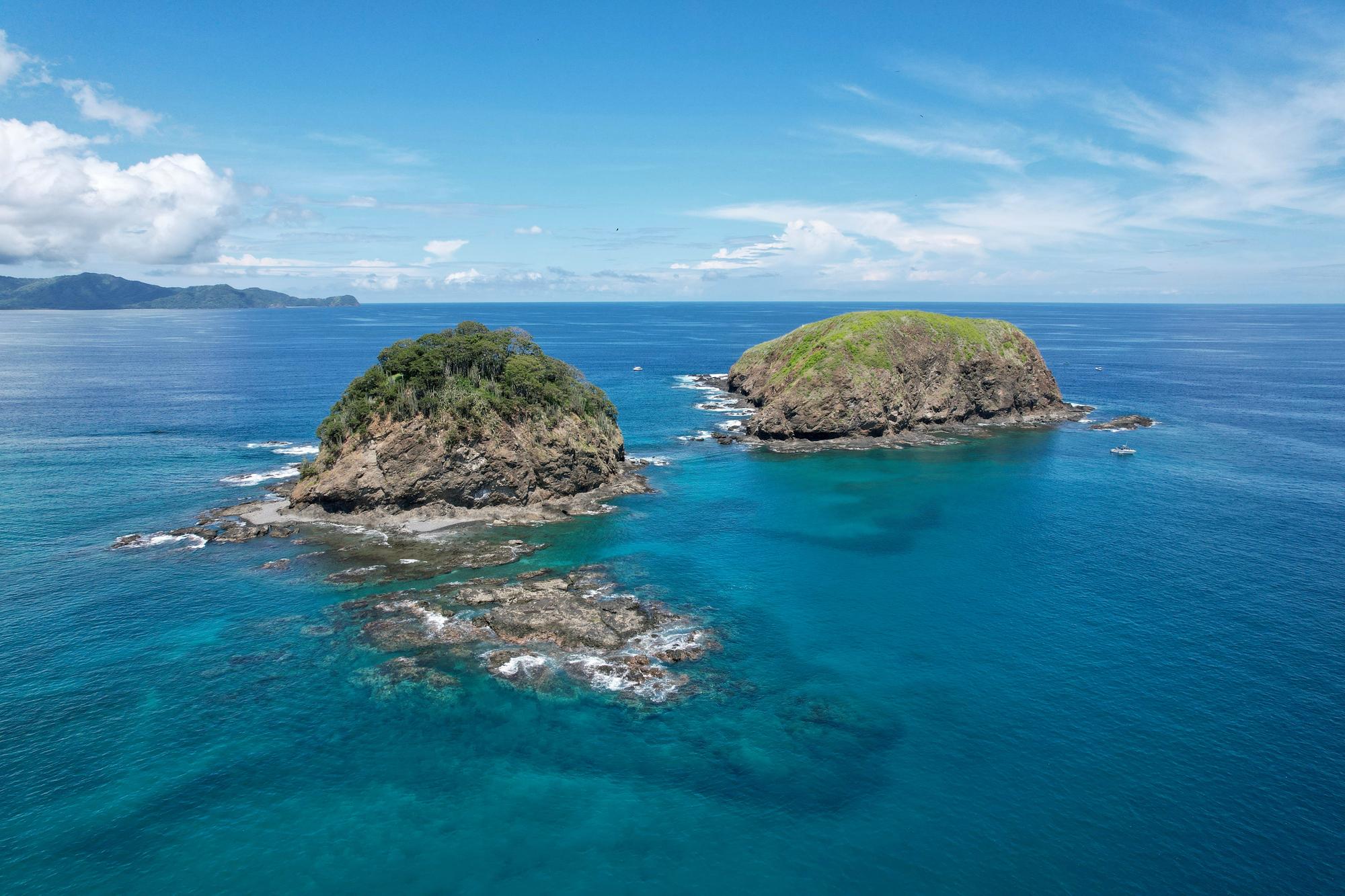 Experience the beauty of Playas Del Coco with its scenic bay, lush nature, and cliffside island views for a perfect vacation spot | Bay, Nature, Island, Cliff, Vacation | Fraser