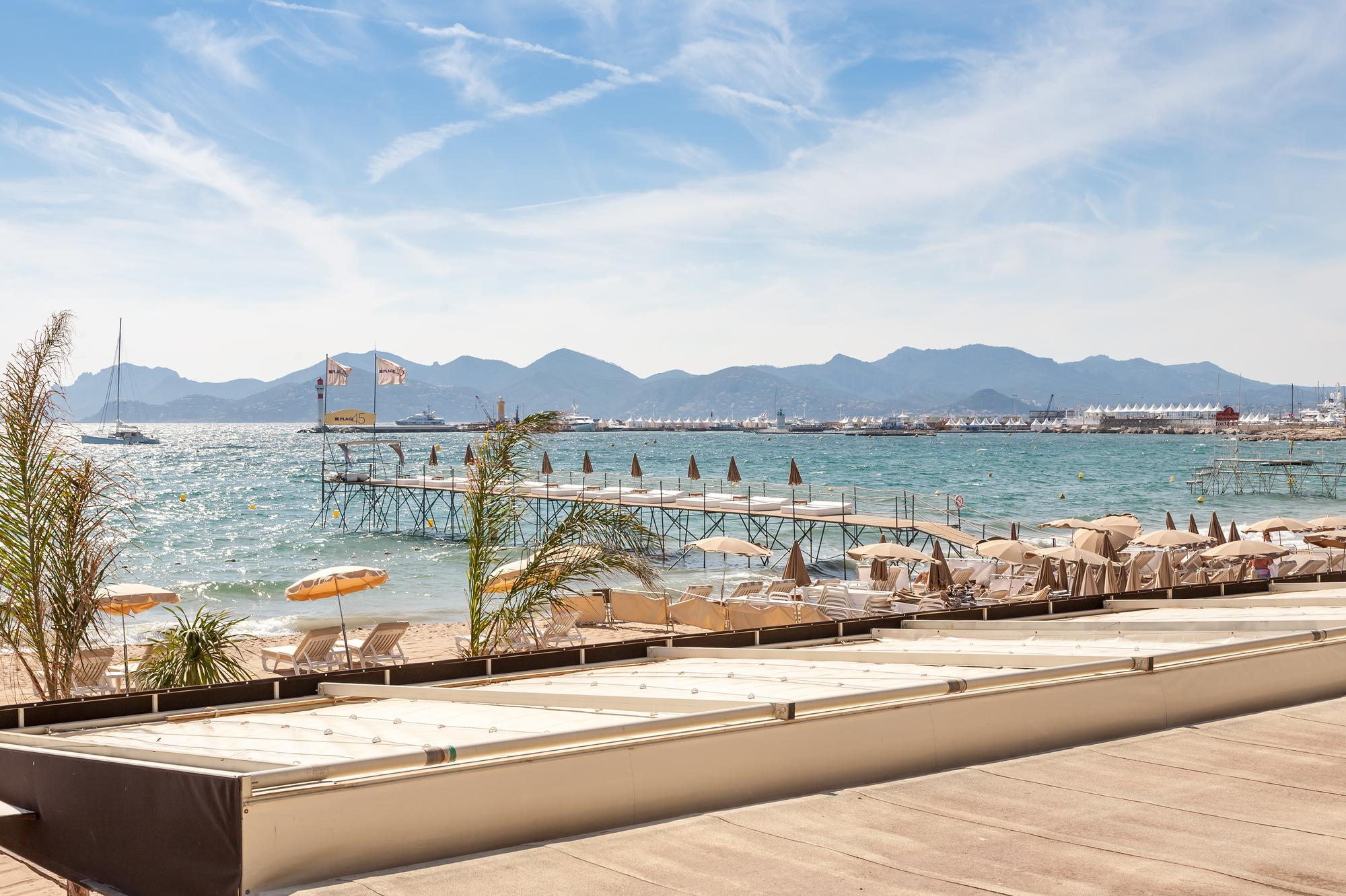 Relax and rejuvenate with sunbathing along the stunning beaches of Cannes, France, a luxurious experience on the Mediterranean itinerary. | Cannes sunbathing, Mediterranean France itinerary, luxury relaxation, Fraser Yachts | fraser