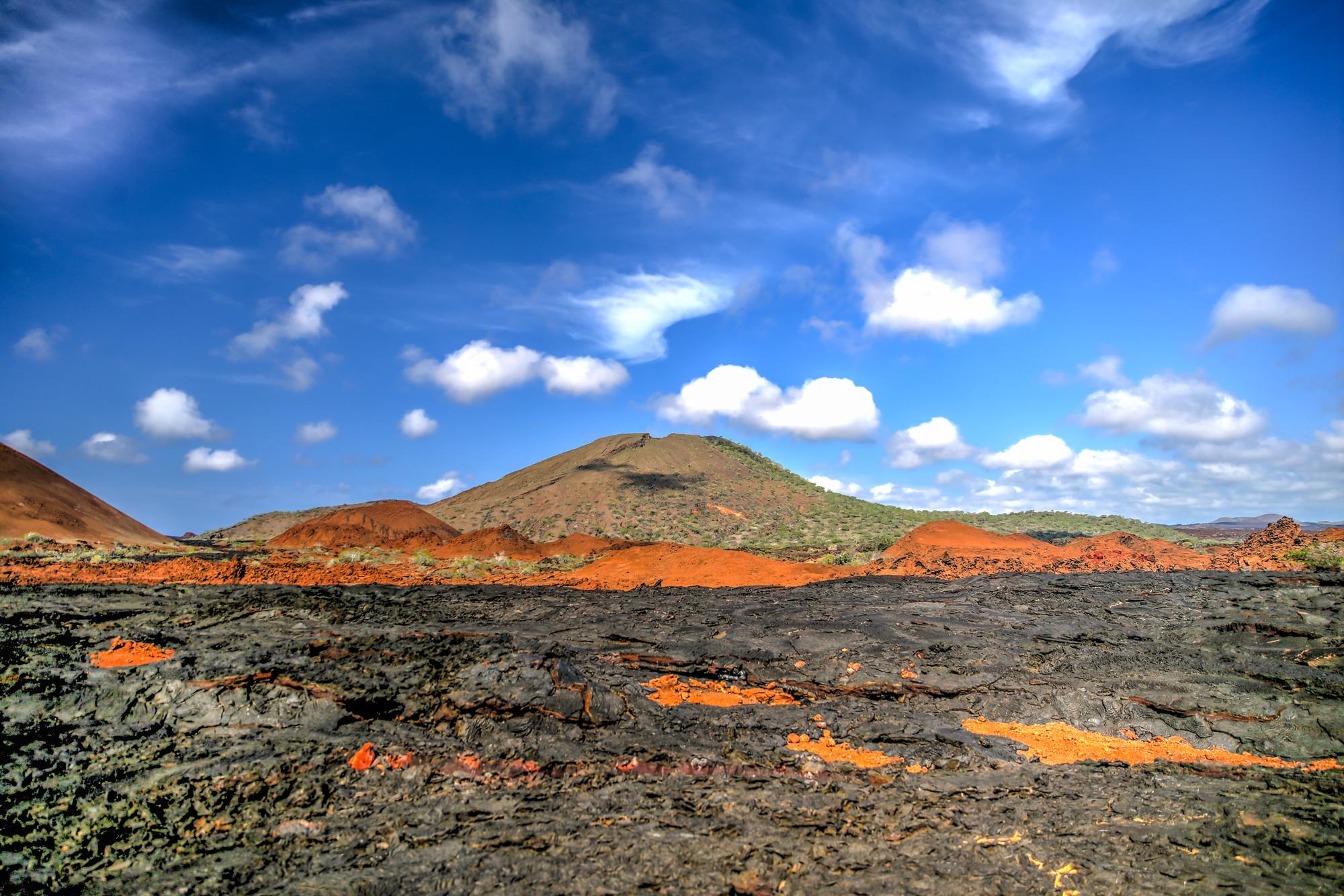 Explore Sullivan Bay's stunning volcanic cinder cones and red lava formations in the Galapagos Islands, a unique natural wonder | Volcano, Cinder Cone, Galapagos, Red Lava, Natural Wonder | Fraser