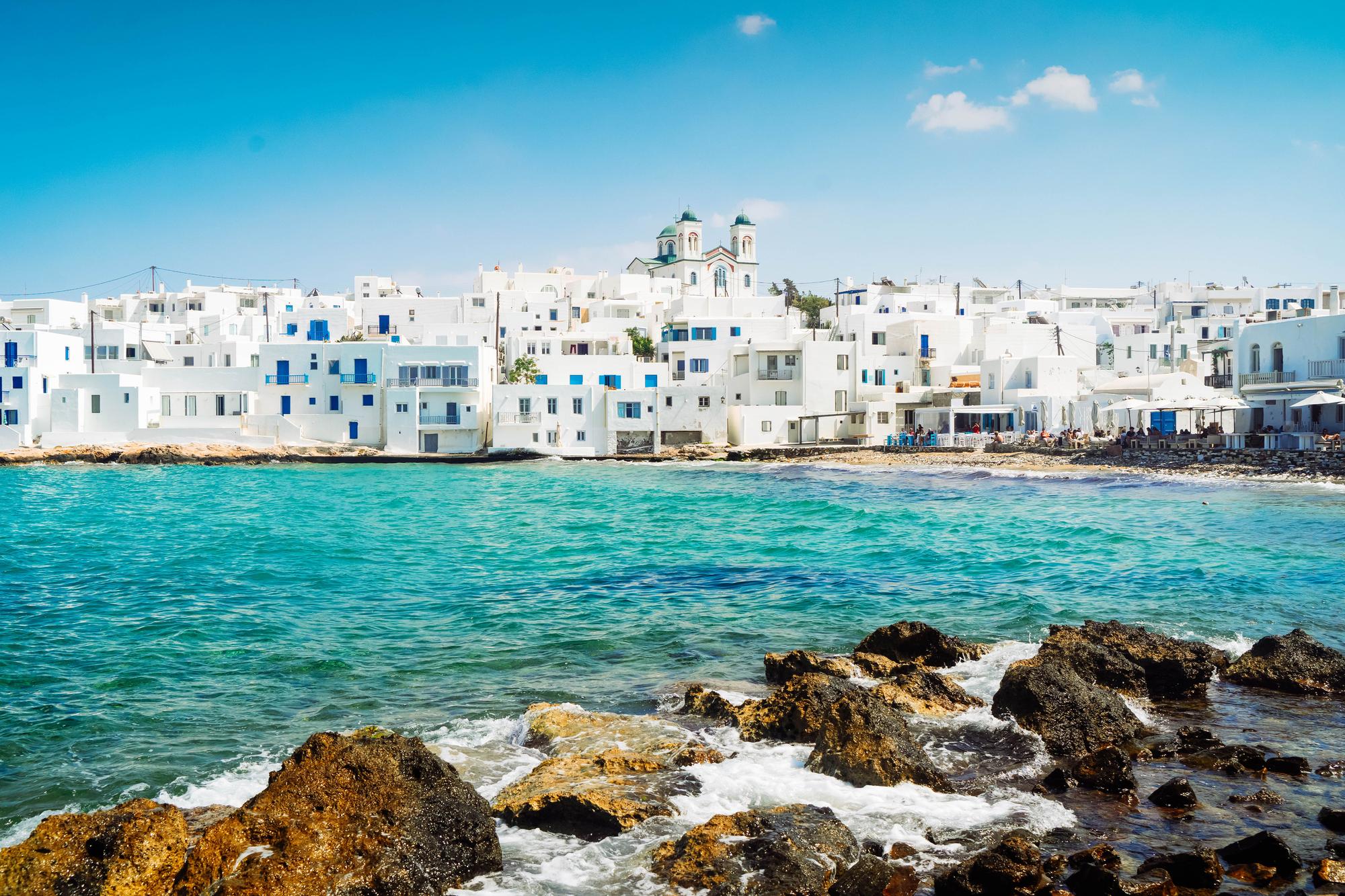 Stroll along the picturesque waterfront of Naoussa in Paros, Greece, a charming spot in the Mediterranean itinerary. | Naoussa waterfront, Paros, Mediterranean Greece itinerary, Greek islands, Fraser Yachts | fraser