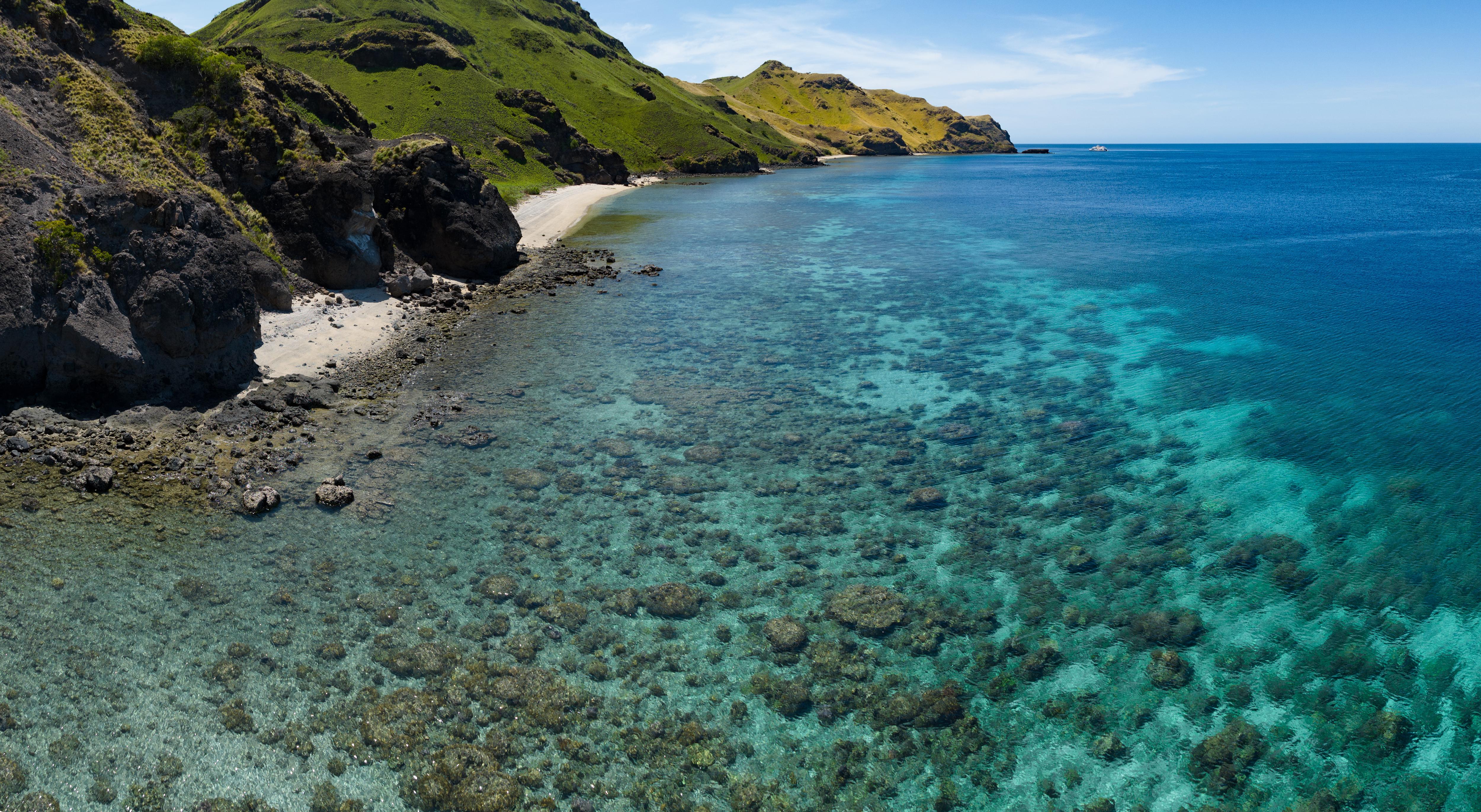 A vibrant coral reef surrounds Gili Banta near Labuan Bajo, Indonesia—part of the Coral Triangle, known for world-class diving and rich marine biodiversity | Fraser