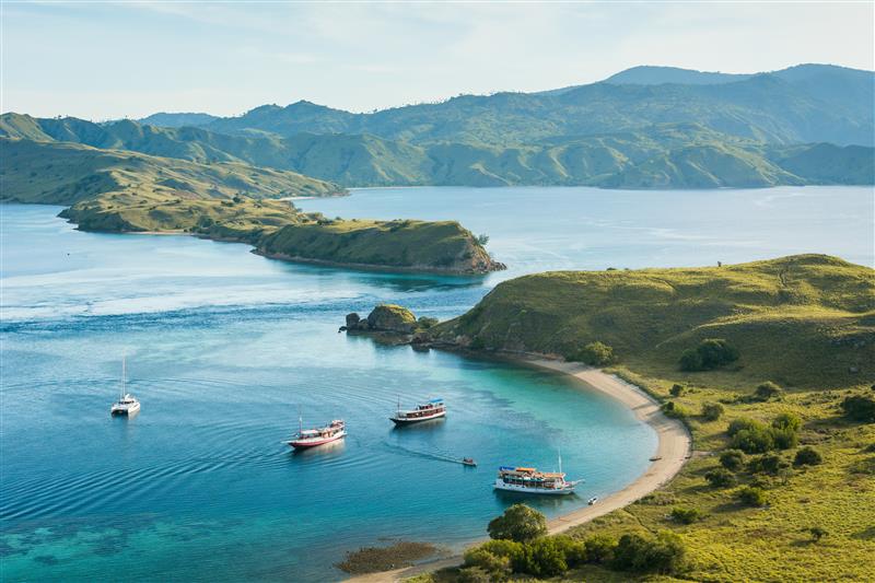 Top view of tourist boats near Gili Lawa at sunset in Komodo National Park, Indonesia—tranquil evening anchorages and panoramic cruising near Labuan Bajo | Frase