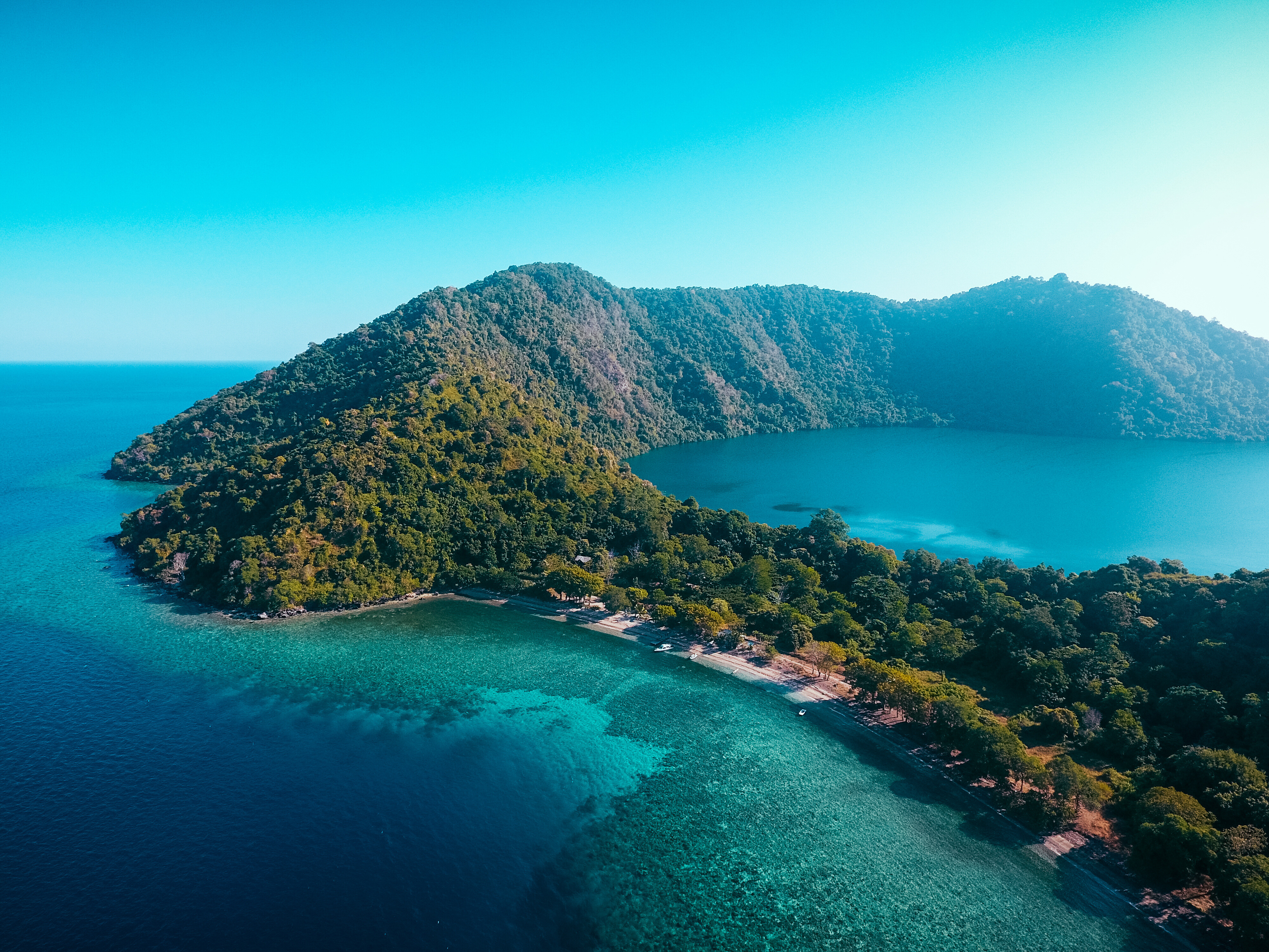 Aerial view of Satonda Island, Indonesia—an idyllic volcanic island in the Ring of Fire, fringed by coral reef and ideal for exploration, swimming, and panoramic views | Fraser