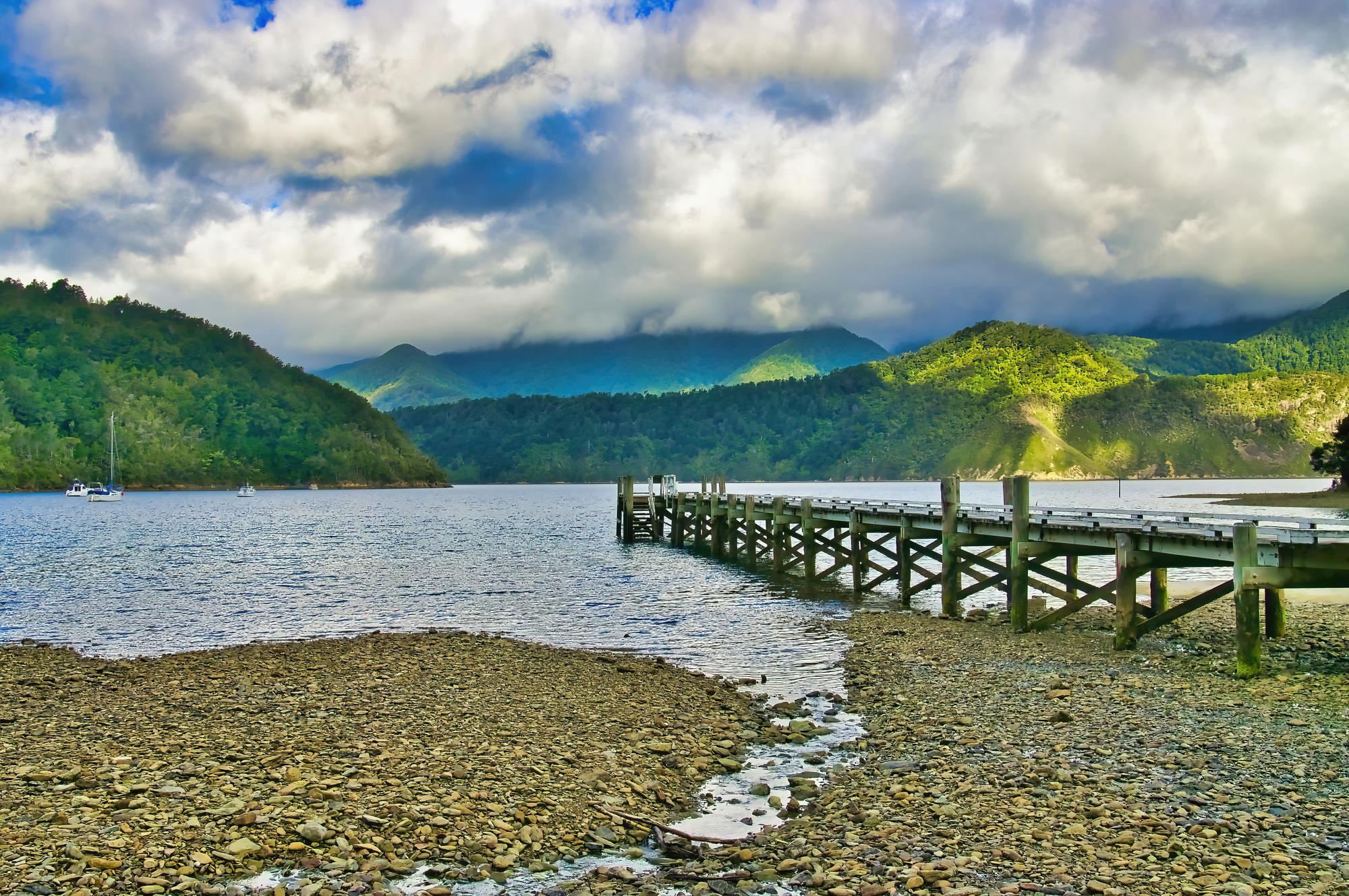 Tennyson Inlet: Natural forest, boats, and picturesque clouds create a perfect travel destination in Marlborough | Boats, Forest, Natural, Clouds, Travel | Fraser