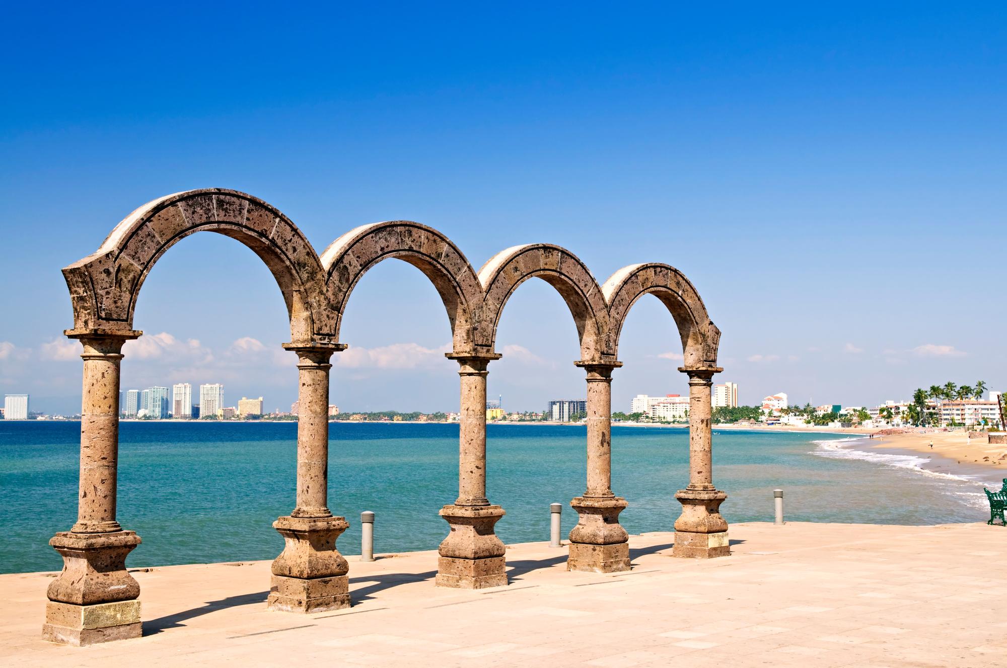 Visit the famous amphitheatre of Los Arcos in Puerto Vallarta, featuring unique archways and beautiful beach views | Amphitheatre, Archways, Beach, Landmark, Attraction | Fraser