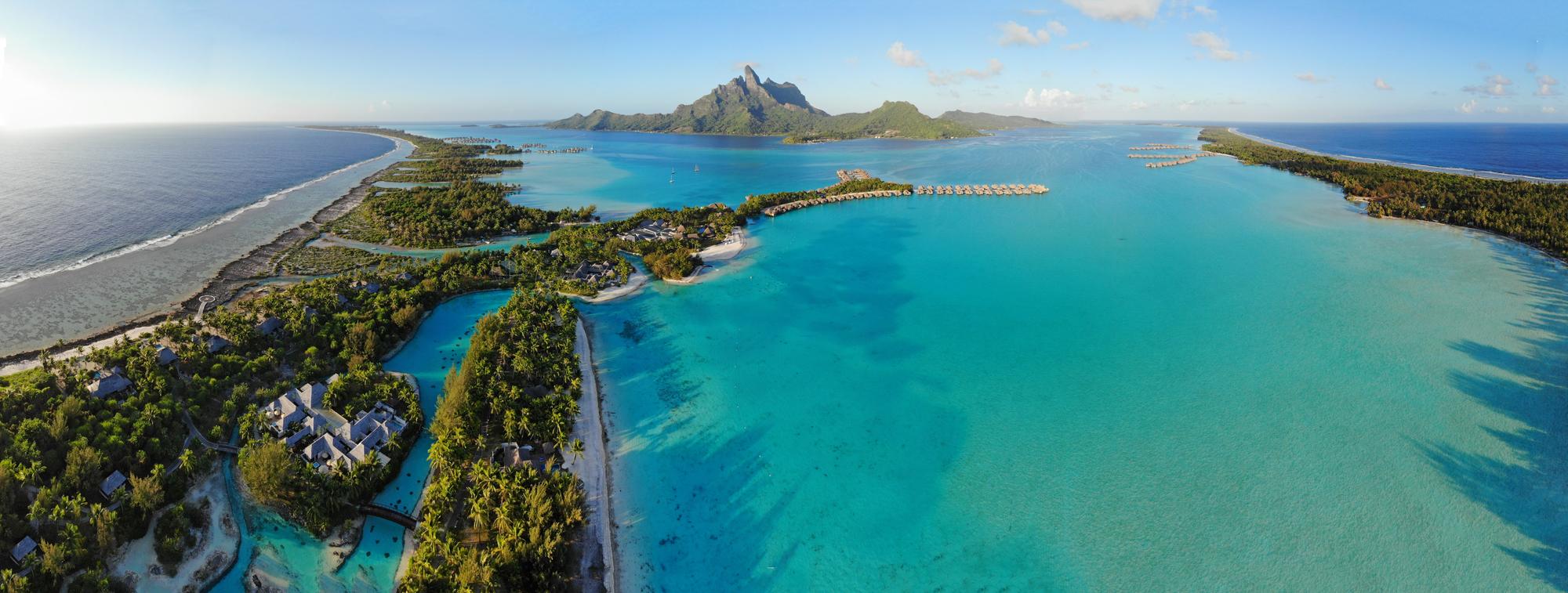 Explore Bora Bora’s breathtaking lagoon and overwater bungalows from the sky, featuring the iconic Mount Otemanu in this summer tourism destination | Aerial, Bungalow, Lagoon, Mont Otemanu, Tourism, Summer | Fraser