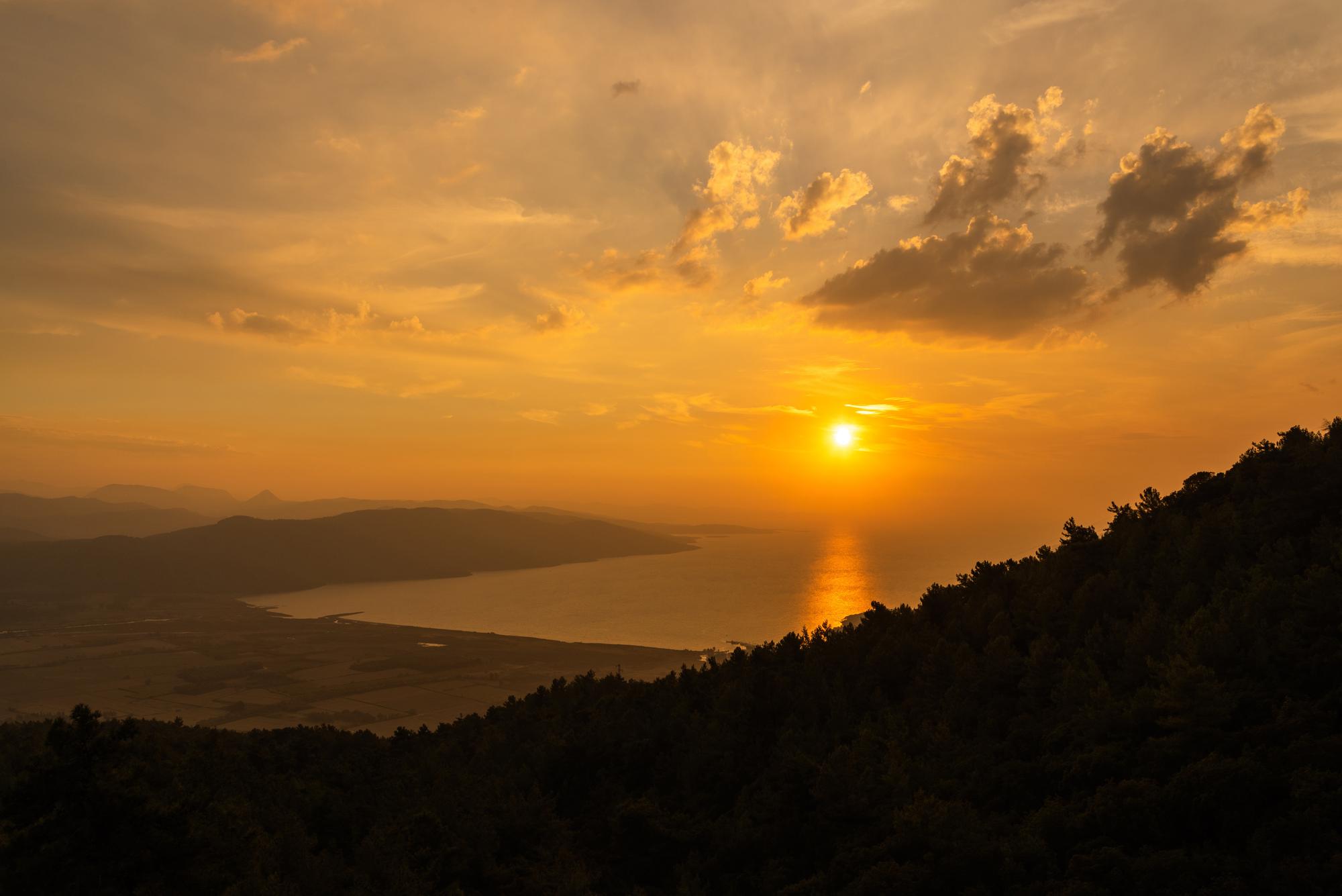 Gaze at the beautiful Aegean coast of Gökova, Turkey, with a stunning horizon painted in rays of orange sunset | Aegean, coast, beautiful, horizon, ray, orange, sunset | Fraser