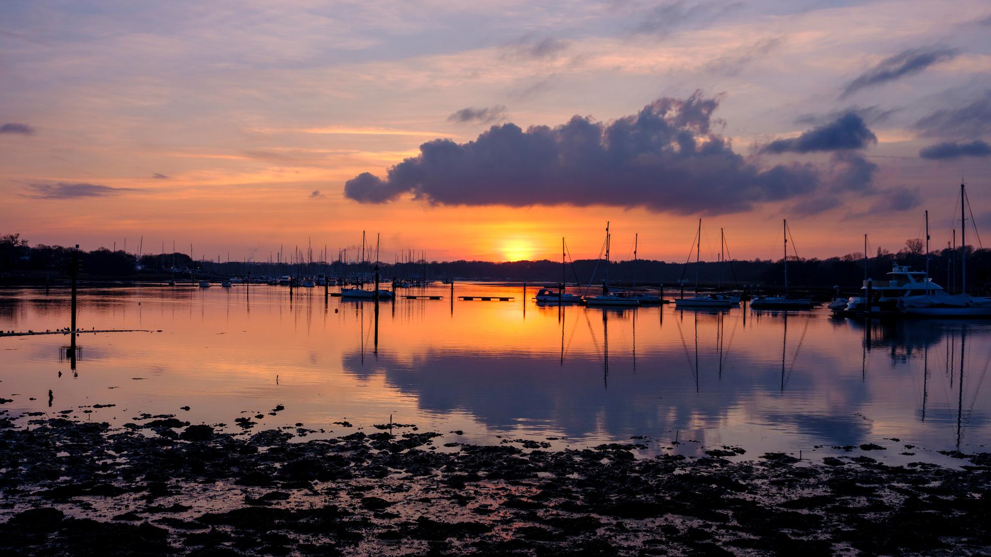 Enjoy the evening calm of Hamble River, with stunning sunset views over the harbor and a quaint village setting | Hamble River, Horizon, Harbor, Evening, Sunset, Warsash, Village | Fraser