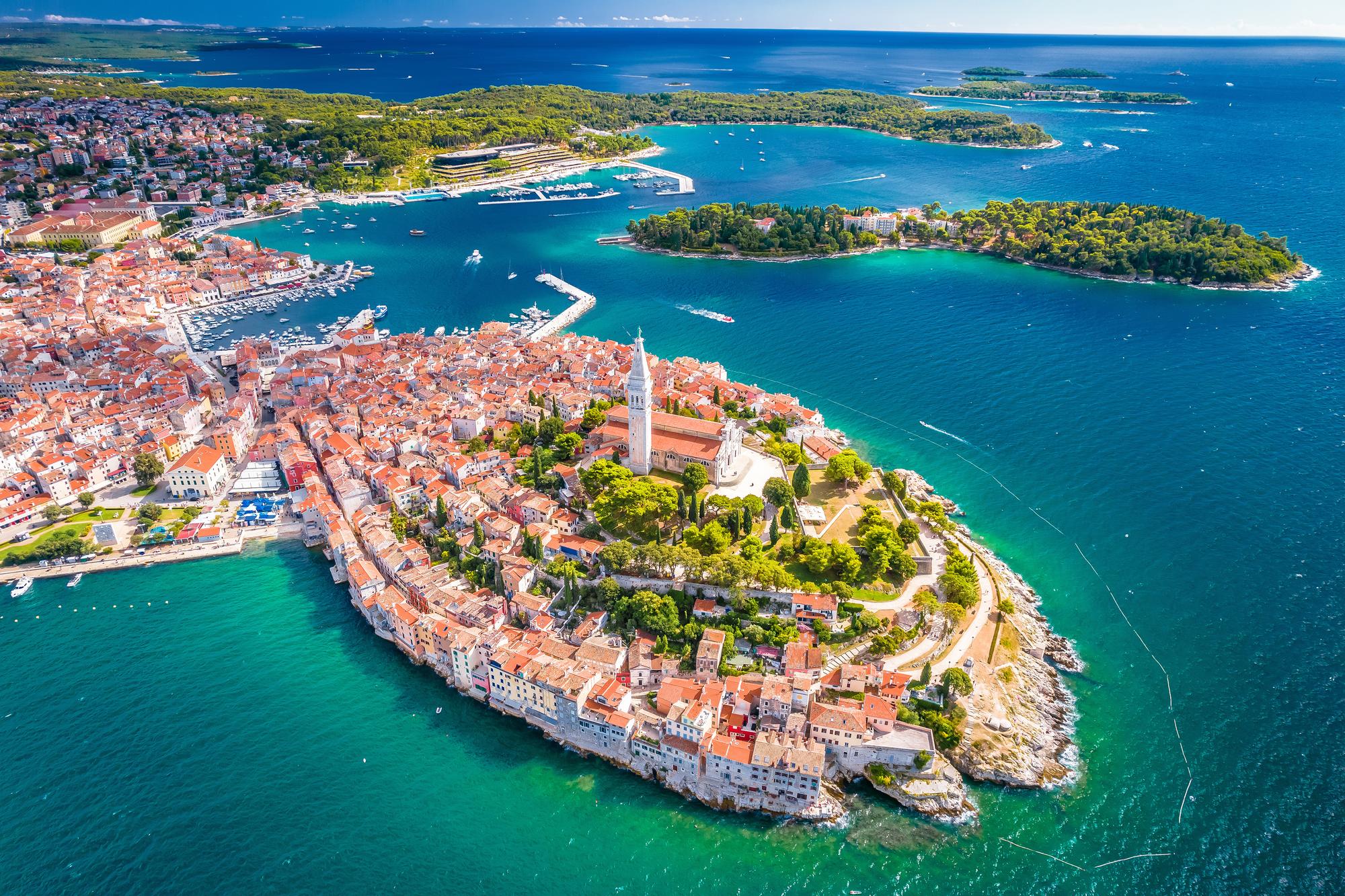 Experience the beauty of Rovinj, Croatia, from an aerial perspective, showcasing its historic charm, tourism appeal, and stunning Adriatic coastline | Aerial, historic, tourism, beautiful, Adriatic, Rovinj, Croatia | Fraser