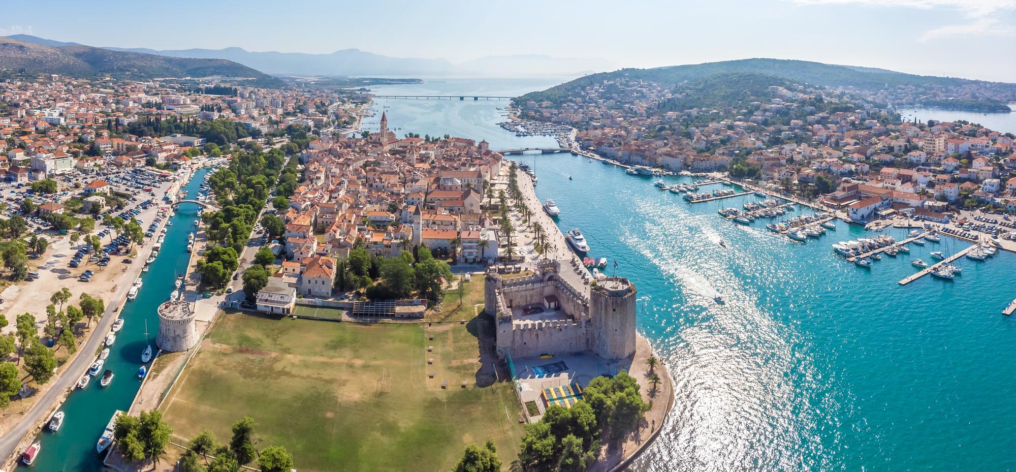 Experience the colorful coastline and UNESCO heritage of Trogir, Croatia, from an aerial perspective, showcasing its stunning seascape | Aerial, colorful, coastline, seascape, UNESCO, Trogir, Croatia | Fraser