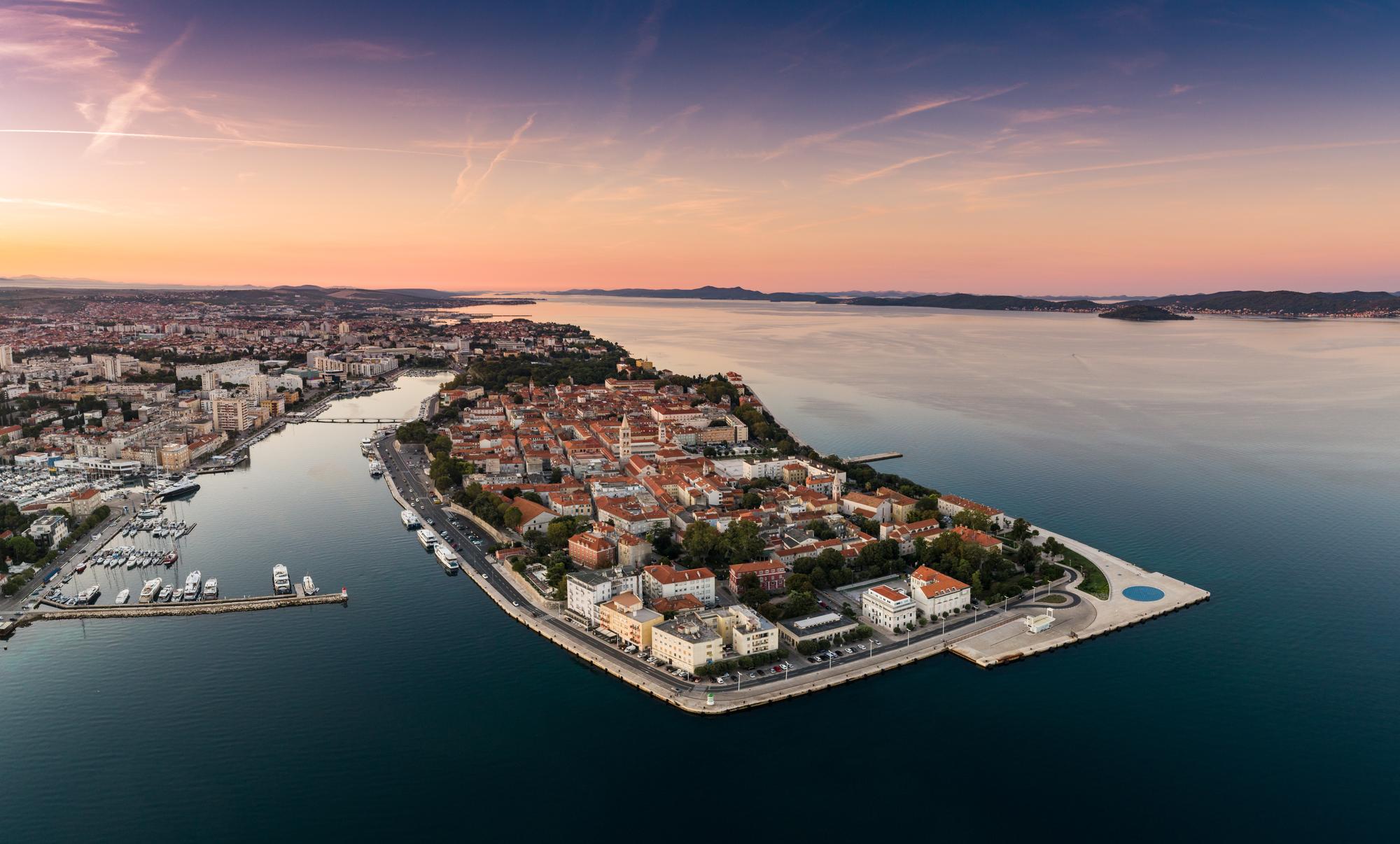 Discover the famous walled city of Zadar, Croatia, with its charming cityscape along the coastline and breathtaking sunsets | City, coastline, famous, sunset, Zadar, Croatia | Fraser