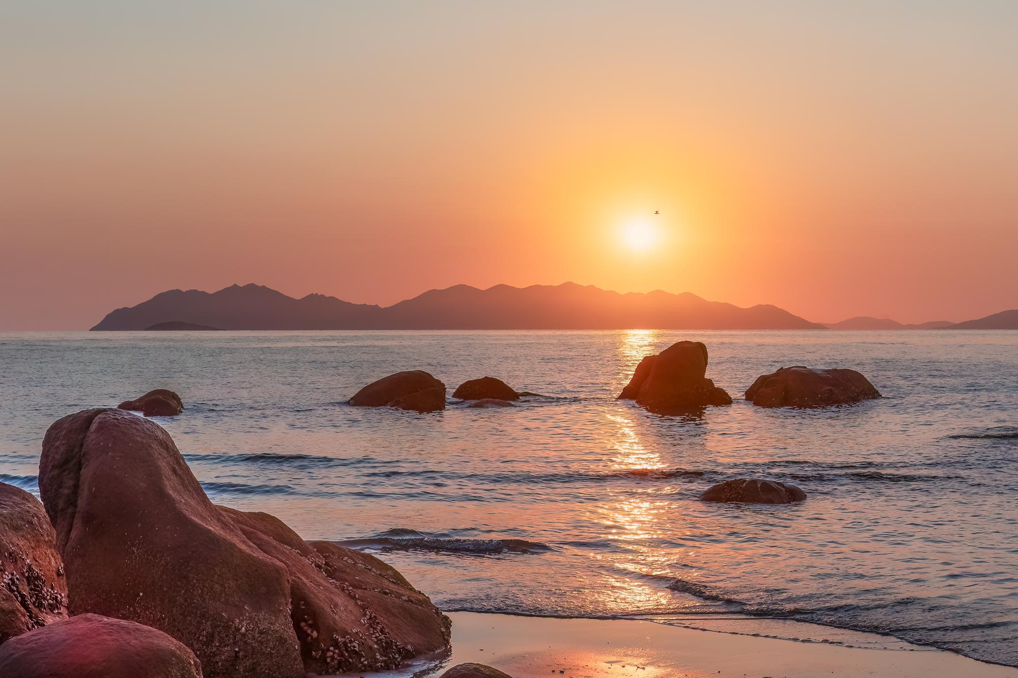 Whitsundays: Serene beach scene with vibrant sunset colors and tranquil Coral Sea, ideal for a peaceful getaway | Beach, Colors, Coral Sea, Peaceful, Calm, Sunset | Fraser